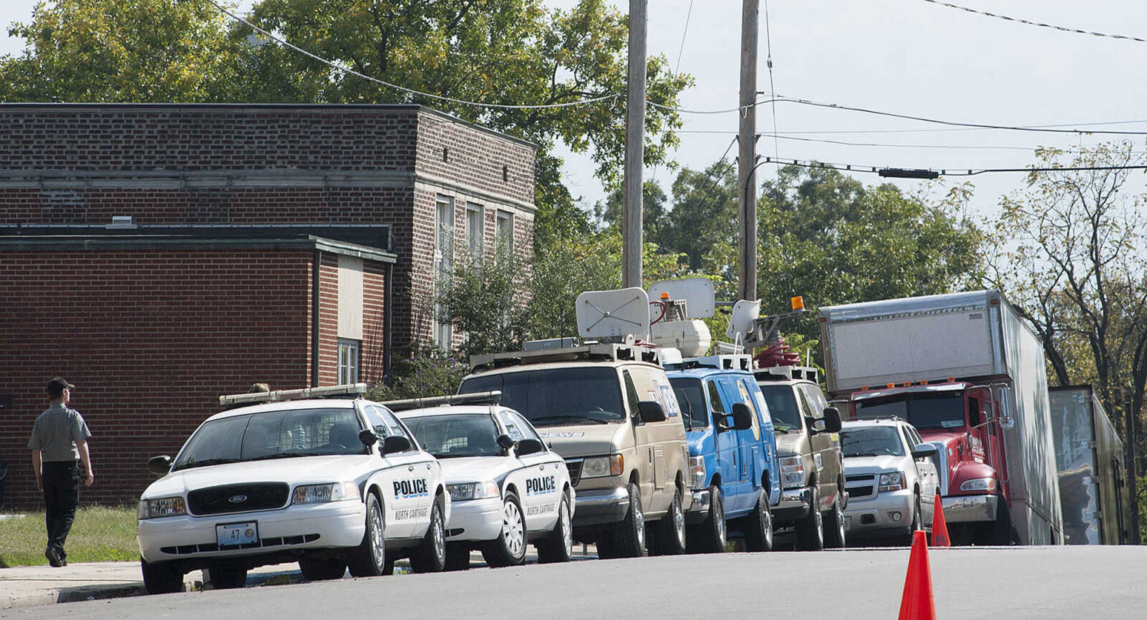 ADAM VOGLER ~ avogler@semissourian.com
Vehicles for the 20th Century Fox feature film "Gone Girl," line Lorimier Street before a scene is filmed at the Common Pleas Courthouse Thursday, Oct. 3, in downtown Cape Girardeau.