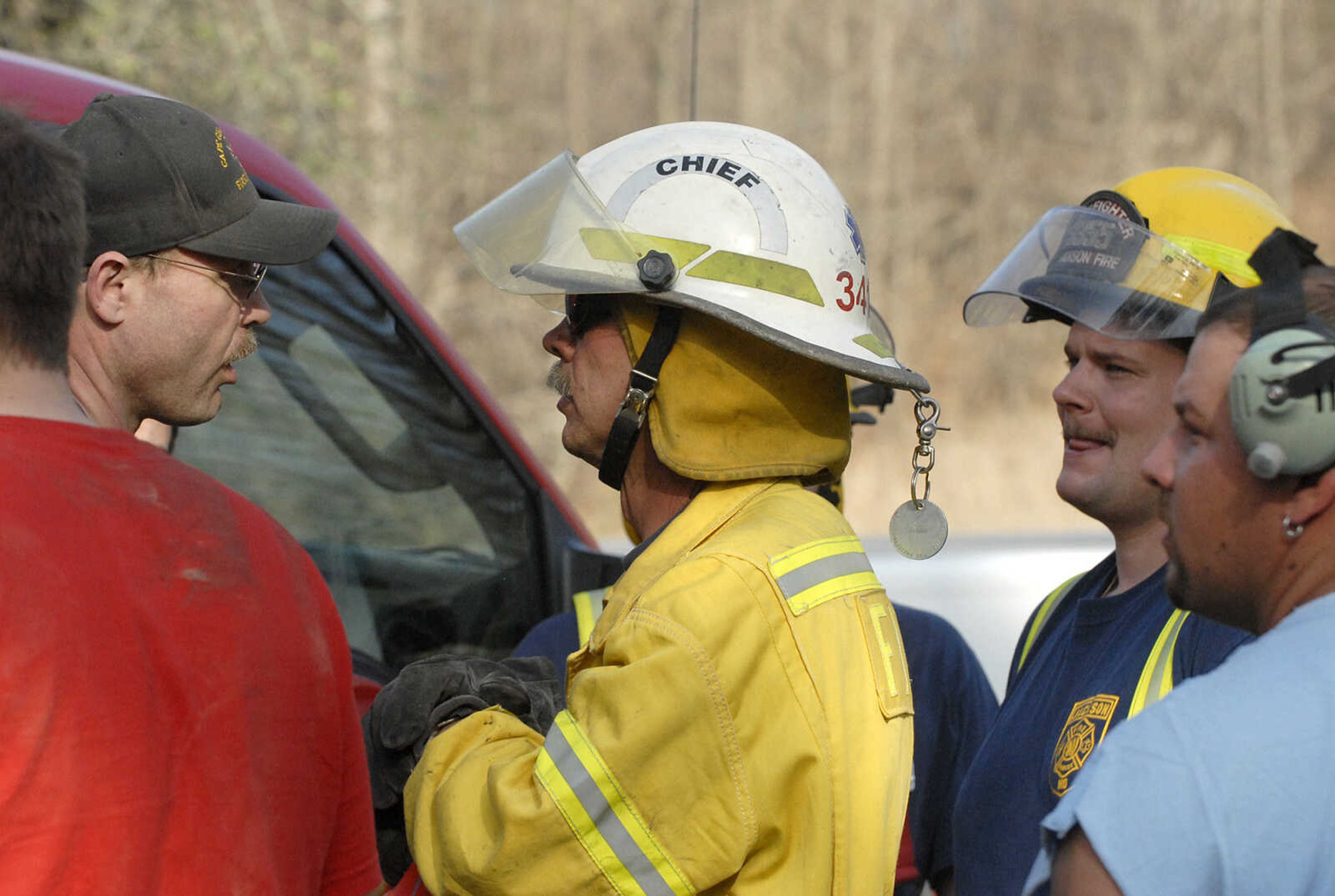 LAURA SIMON~lsimon@semissourian.com
Fruitland fire chief Dean Riley speaks with fire crews about a natural cover fire off of Cissus Lane near Neelys Landing Sunday, April 3, 2011. Firefighters from Cape Girardeau, Perry, Scott, and Bollinger Counties contained the blaze that ravaged 50 acres of land.