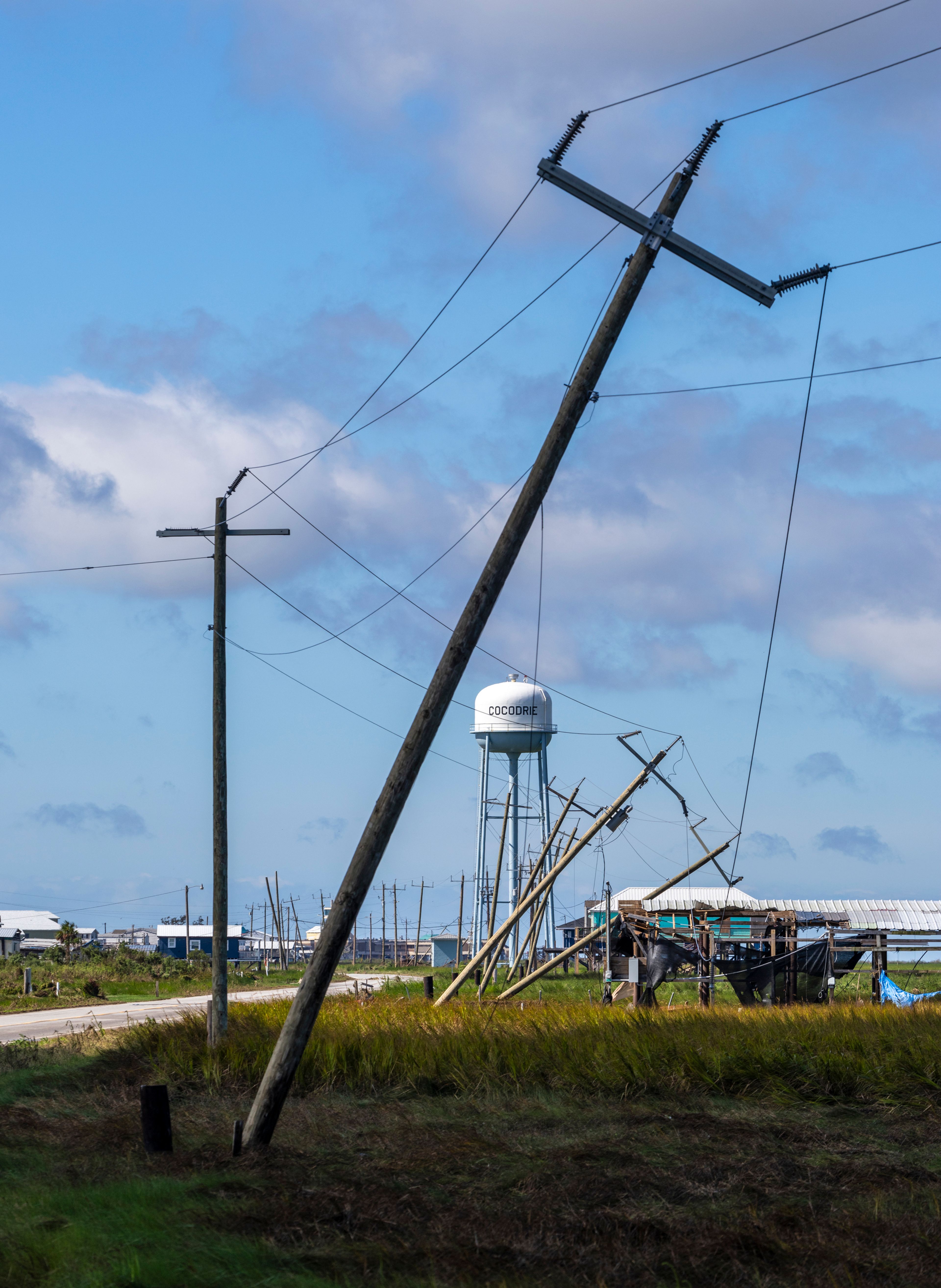 Utility poles lean from Hurricane Francine, Thursday, Sept. 12, 2024, in Terrebonne Parish, La. (Chris Granger/The Times-Picayune/The New Orleans Advocate via AP)