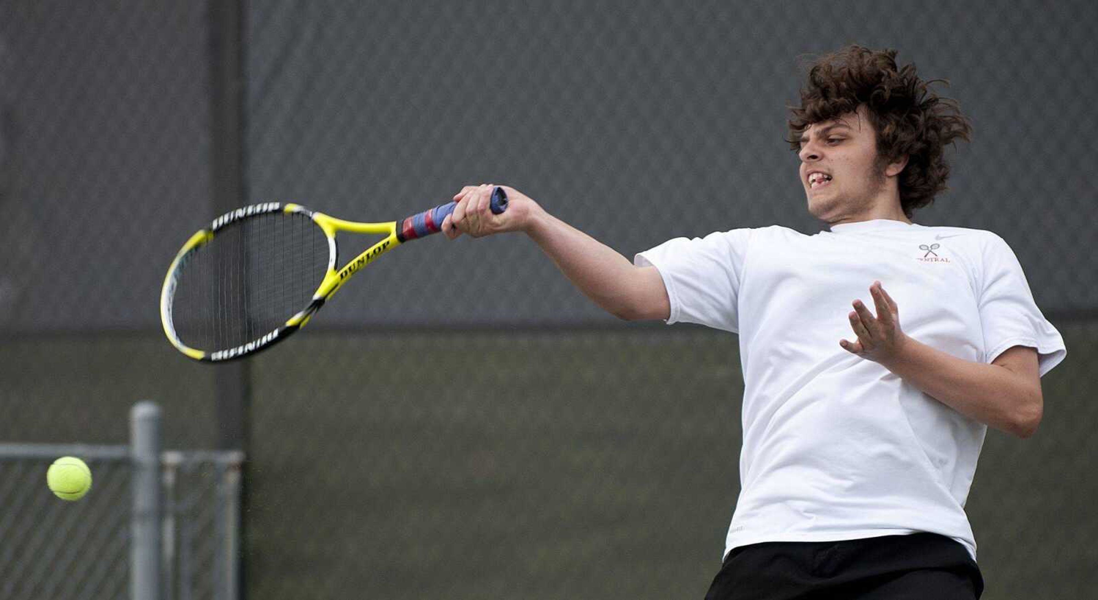 Central sophomore Alex Mailes hits a forehand during his 8-1 win over Dexter sophomore Ethan Flowers, Wednesday, April 2, at Central High School. (Adam Vogler)