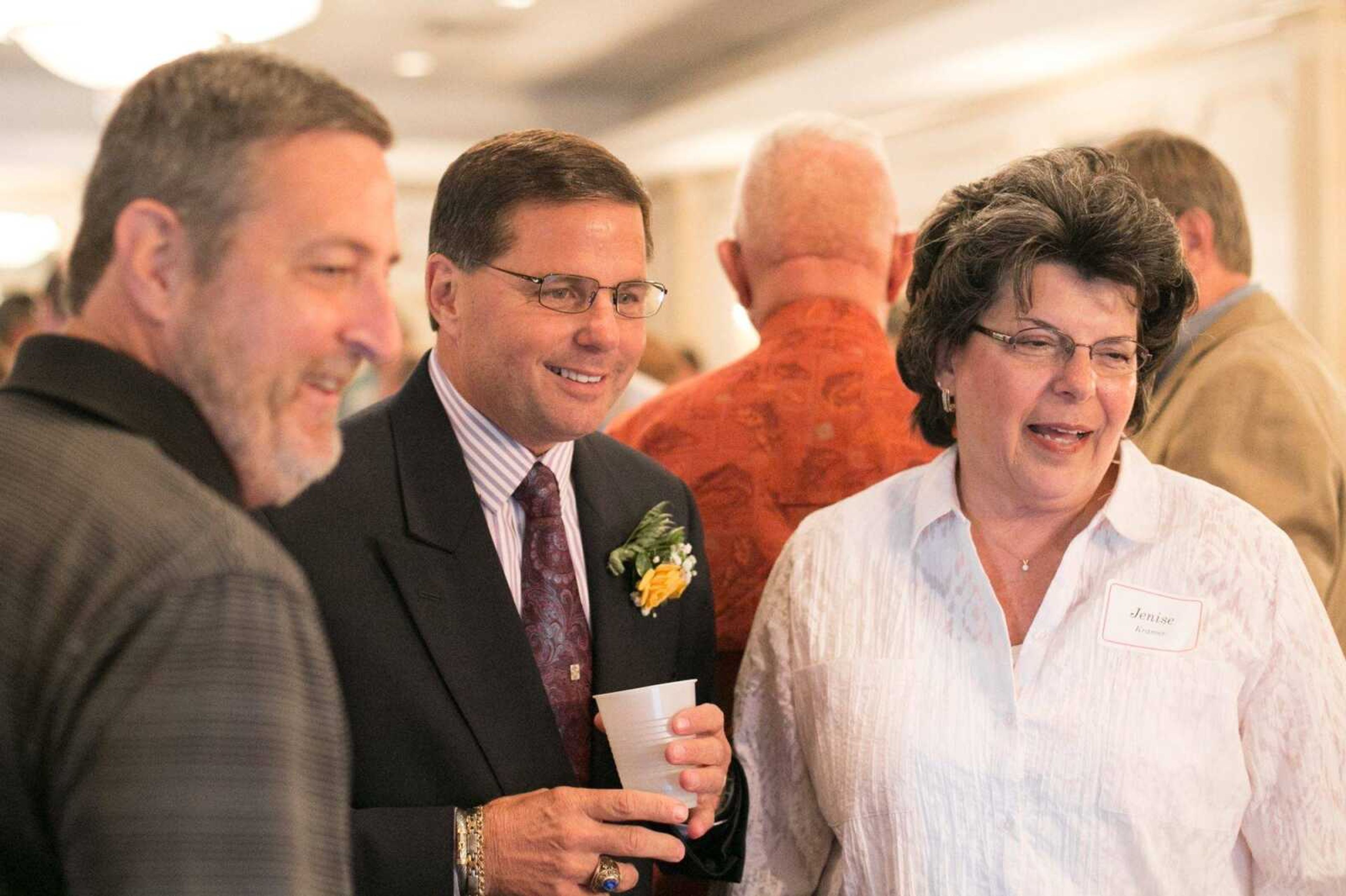 Longtime manager of the Cape Girardeau Schnucks, Dennis Marchi watches a slideshow of his career with guests at his retirement party Friday, Aug. 21, 2015 at the Drury Lodge. (Glenn Landberg)