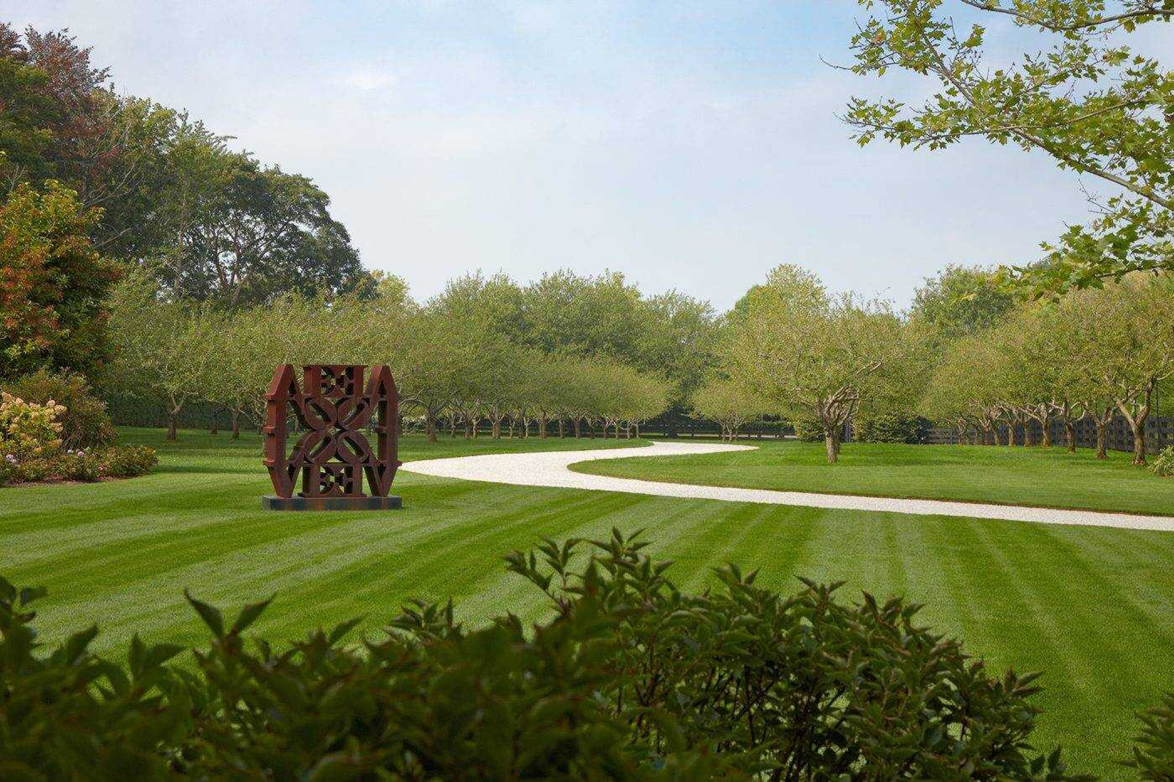 This undated photo provided by HOLLANDERdesign/Landscape Architects shows a sculpture by artist Robert Indiana and in a residential garden on the east end of Long Island in New York. The garden was designed by landscape architect Edmund Hollander.