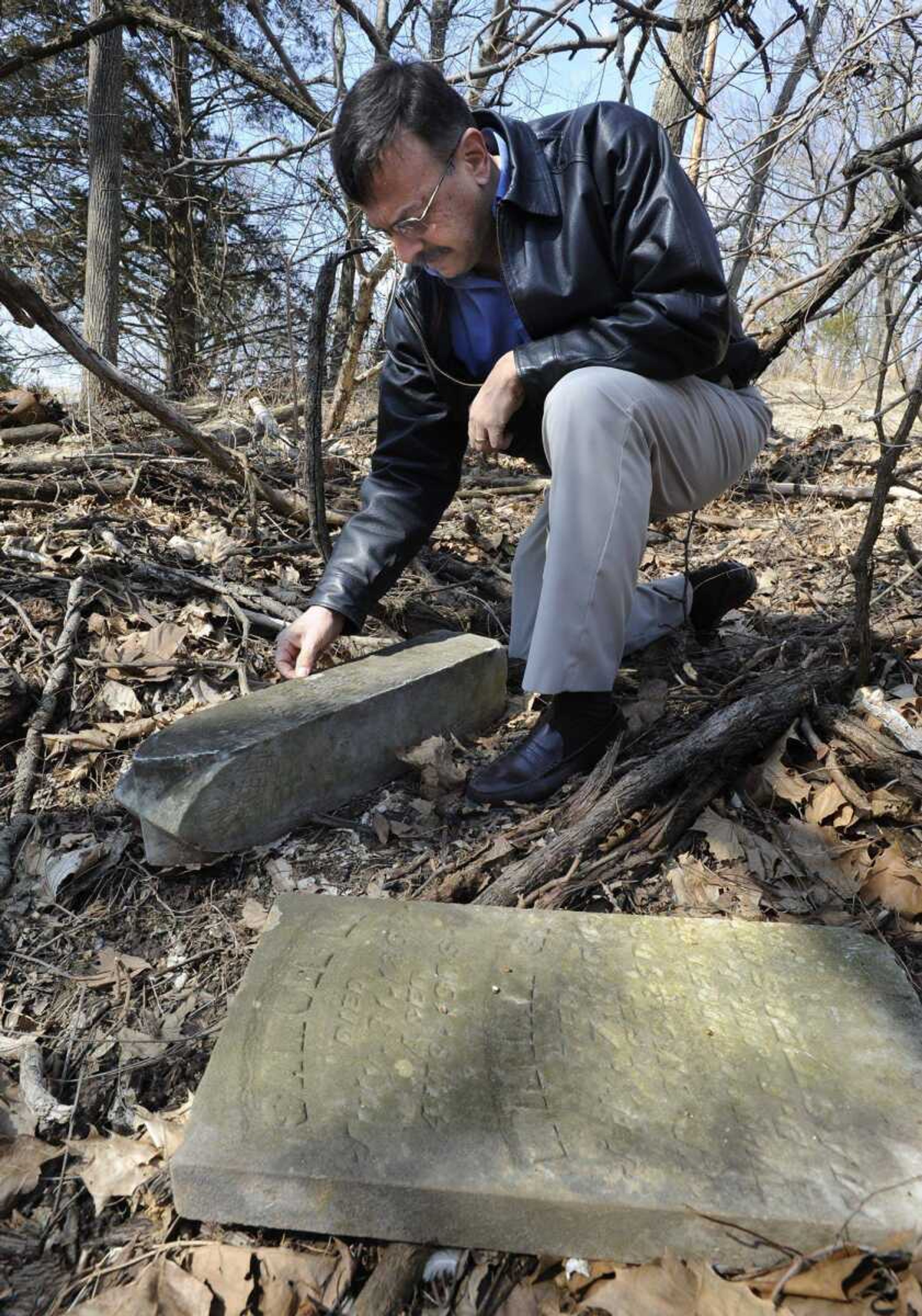 Dave Soto shows two headstones that were stolen and found on property he manages in Cape Girardeau County. (Fred Lynch)