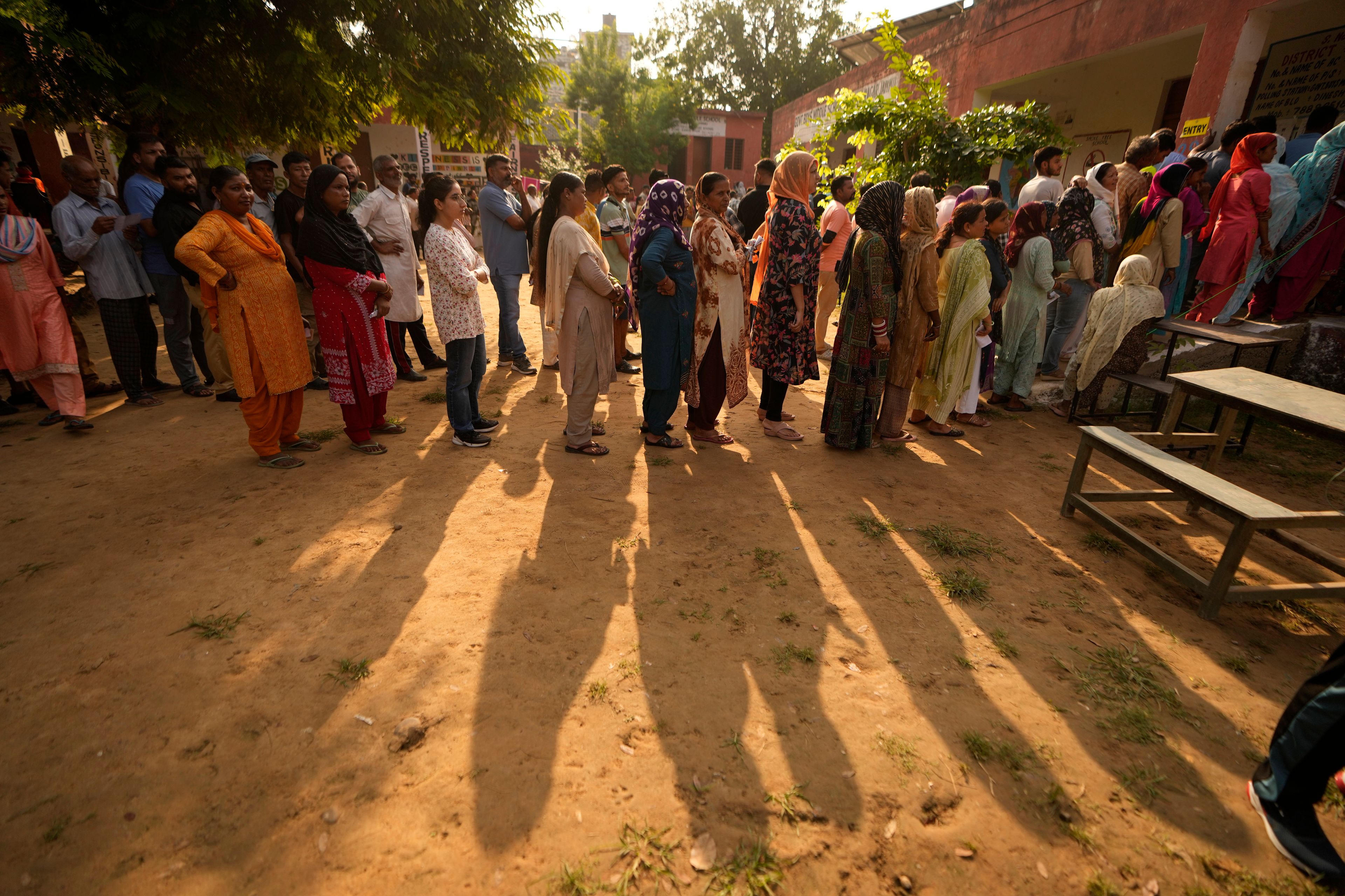 People queue up to cast their vote at a polling booth during the third phase of the Jammu and Kashmir Assembly election in Jammu, India, Tuesday, Oct. 1, 2024. (AP Photos/Channi Anand)