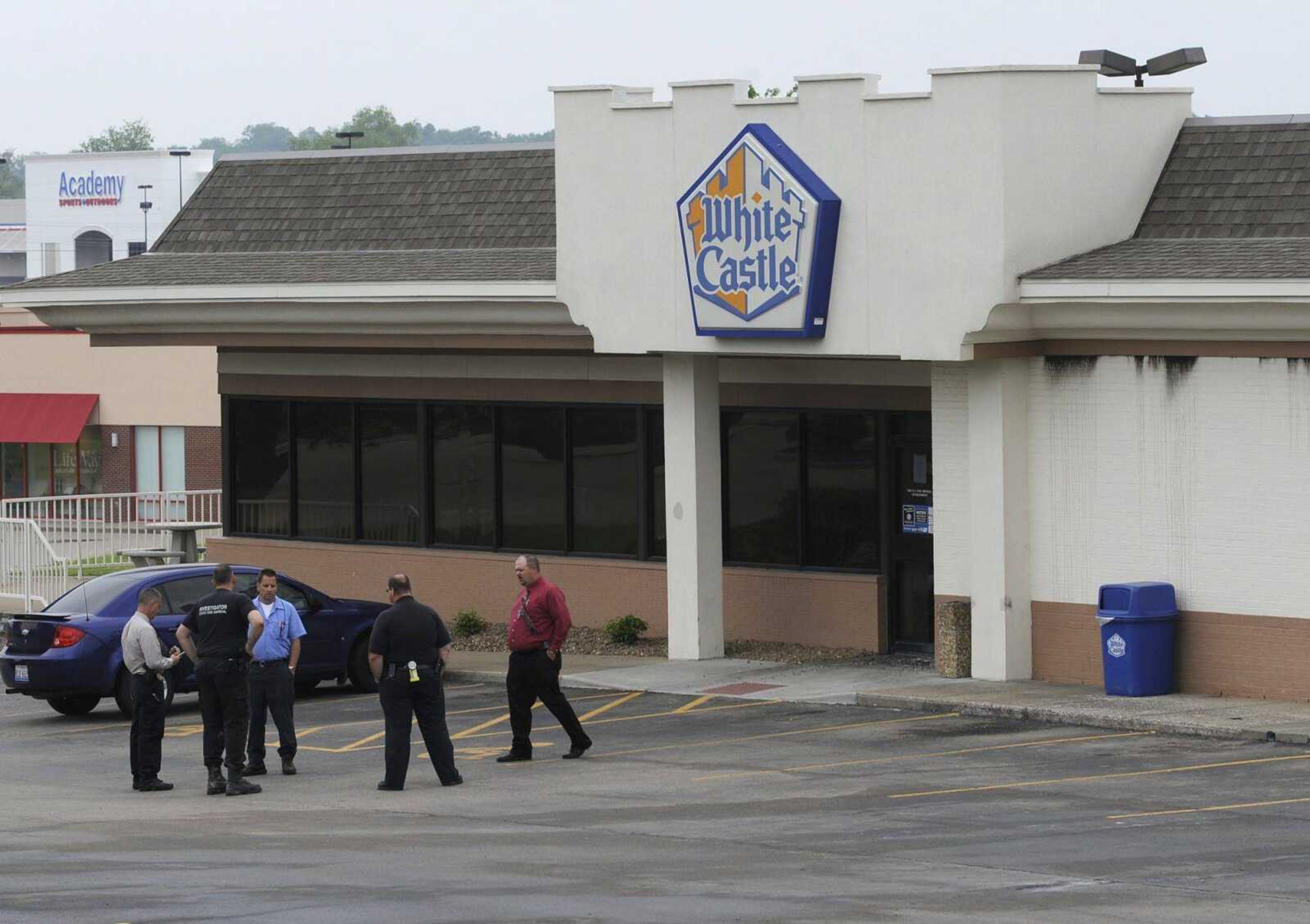 Fire investigators stand outside the White Castle restaurant after an early-morning fire Monday, May 12, 2014 on Siemers Drive in Cape Girardeau. (Fred Lynch)