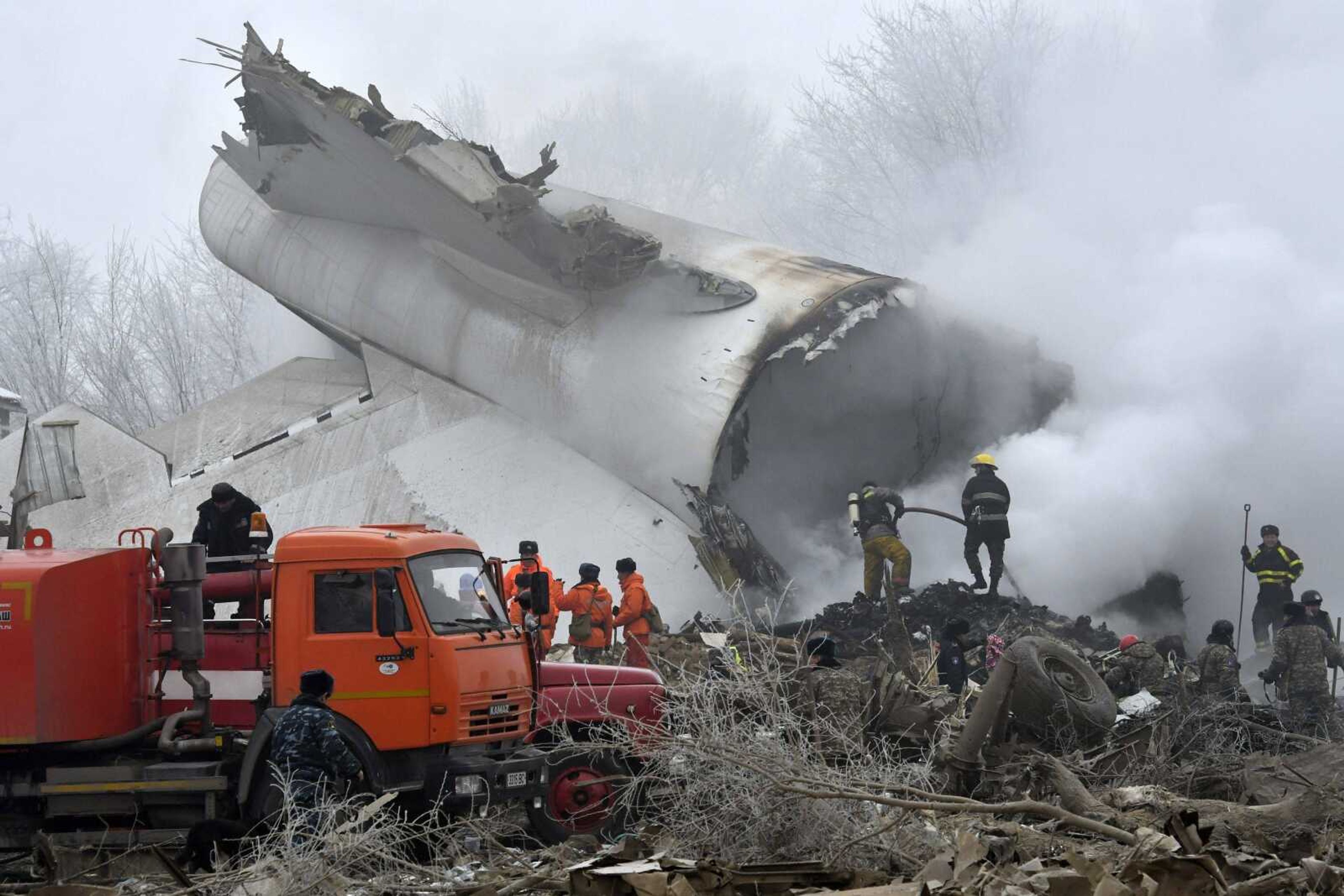 Kyrgyz Emergency Ministry officials work among remains Monday of a crashed Turkish Boeing 747 cargo plane at a residential area outside Bishkek, Kyrgyzstan. The cargo plane crashed Monday morning, killing people in the residential area adjacent to the Manas airport as well as those on the plane.