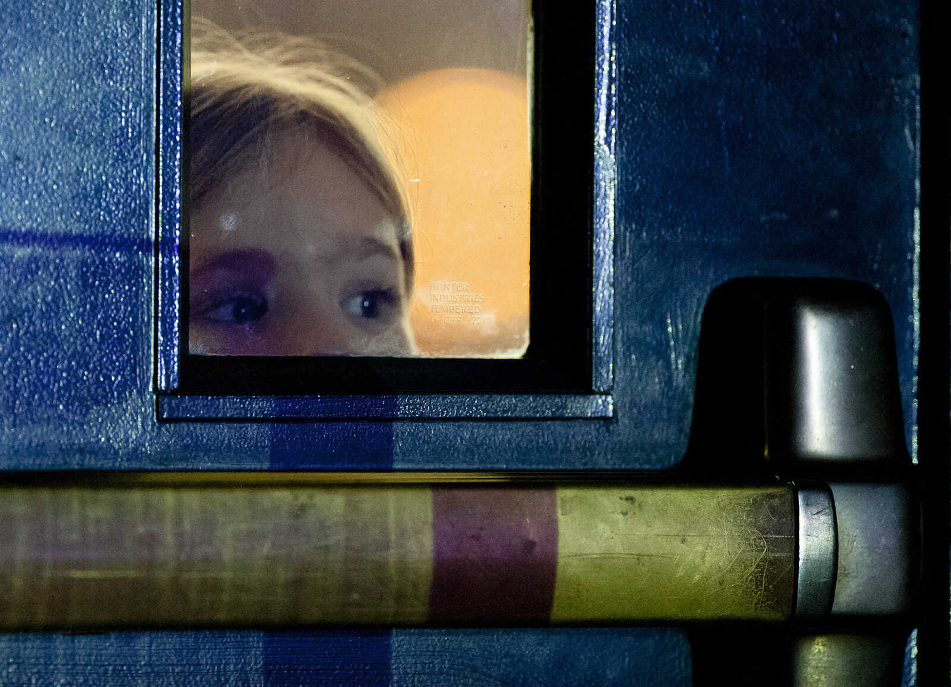 Maria Seyer peeks through a window in a door as Mandisa performs as part of the Hits Deep Tour Friday, Dec. 13, at the Show Me Center in Cape Girardeau. The Christian singer, whose given name is Mandisa Hundley, was a contestant on the fifth season of ŇAmerican Idol,Ó in 2006.