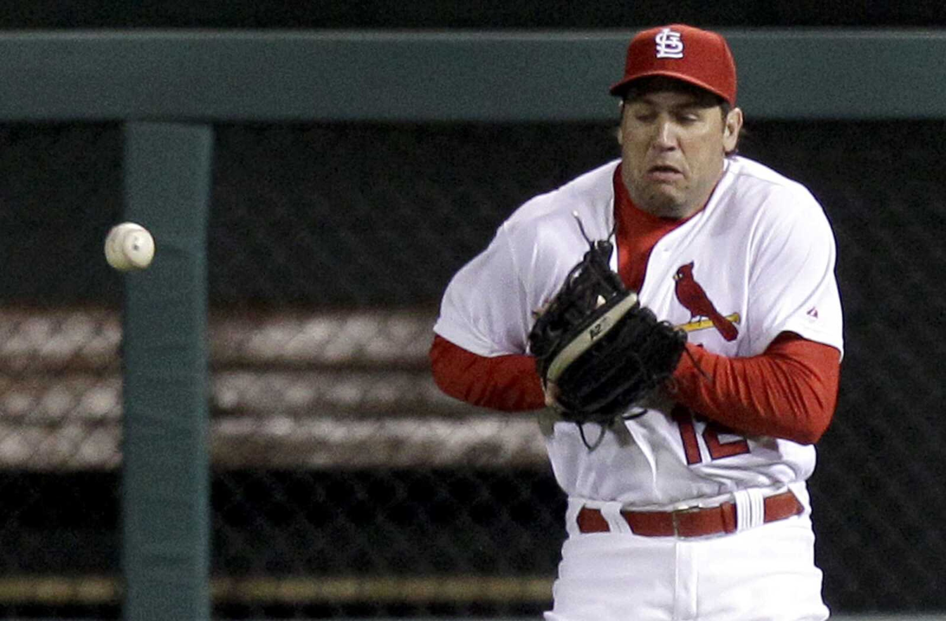 St. Louis Cardinals right fielder Lance Berkman misplays a single by Pittsburgh Pirates' Neil Walker during the fourth inning of a baseball game Monday, April 4, 2011, in St. Louis. Berkman was charged with an error and Walker advanced to second. (AP Photo/Jeff Roberson)