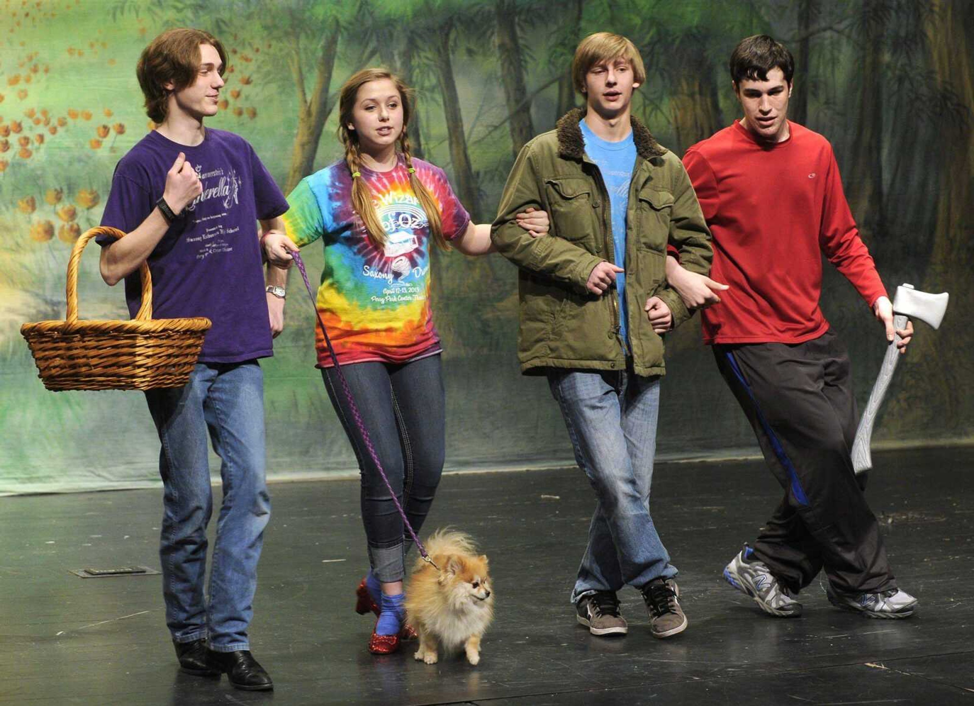 Dorothy, played by Jacquelyn Kiefner, is off to see the Wizard, along with the Scarecrow, Ben Spiecker, left, the Cowardly Lion, Landon Petzoldt, and the Tinman, Elwood Voss, in the Saxony Lutheran High School production of &#8220;The Wizard of Oz.&#8221; Toto is played by Little Bear. (Fred Lynch)