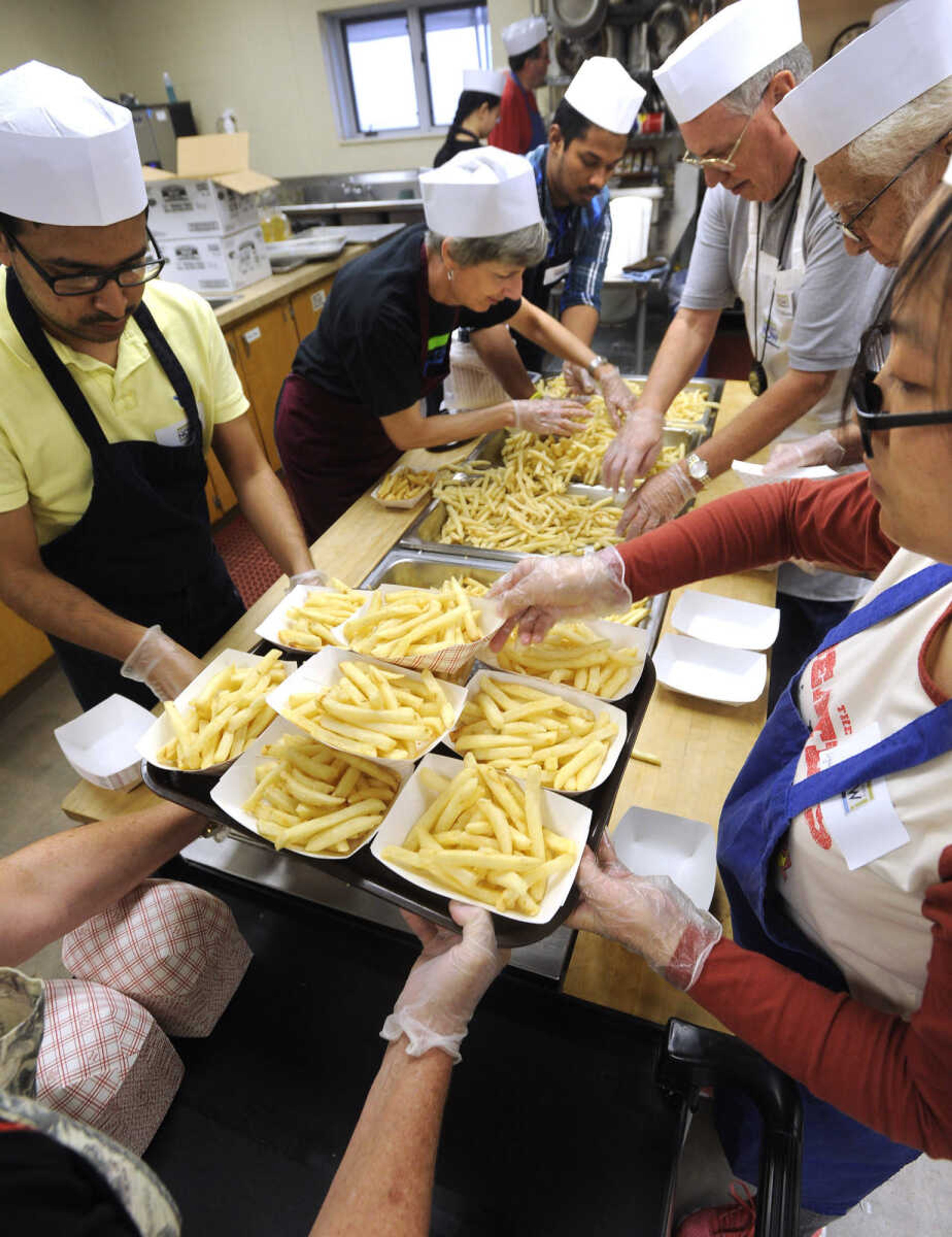 FRED LYNCH ~ flynch@semissourian.com
The kitchen crew prepares French fries for Wimpy's Day Saturday, Sept. 19, 2015 at Centenary United Methodist Church in Cape Girardeau.