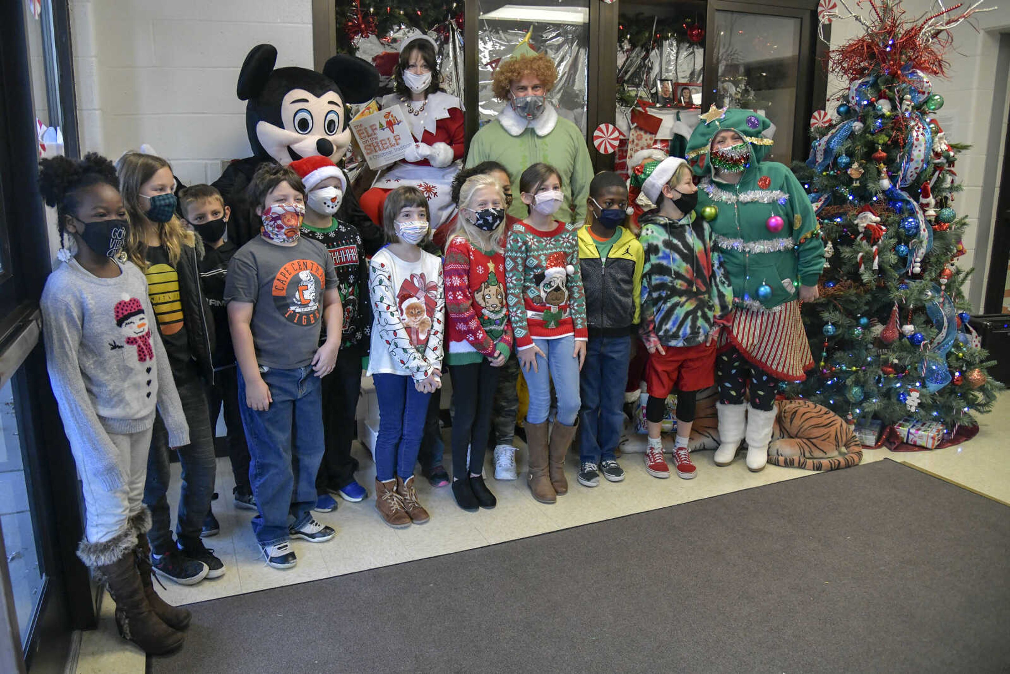 A class poses with&nbsp;Assistant Superintendent&nbsp;Josh Crowell as Mickey Mouse, Principal Julia Unnerstall as Elf on the Shelf, Psychological Examiner Stephanie Craft as a Christmas tree and Superintendent Dr. Neil Glass as Buddy the Elf for a photo at Alma Schrader Elementary School in Cape Girardeau on Thursday, Dec. 17, 2020.