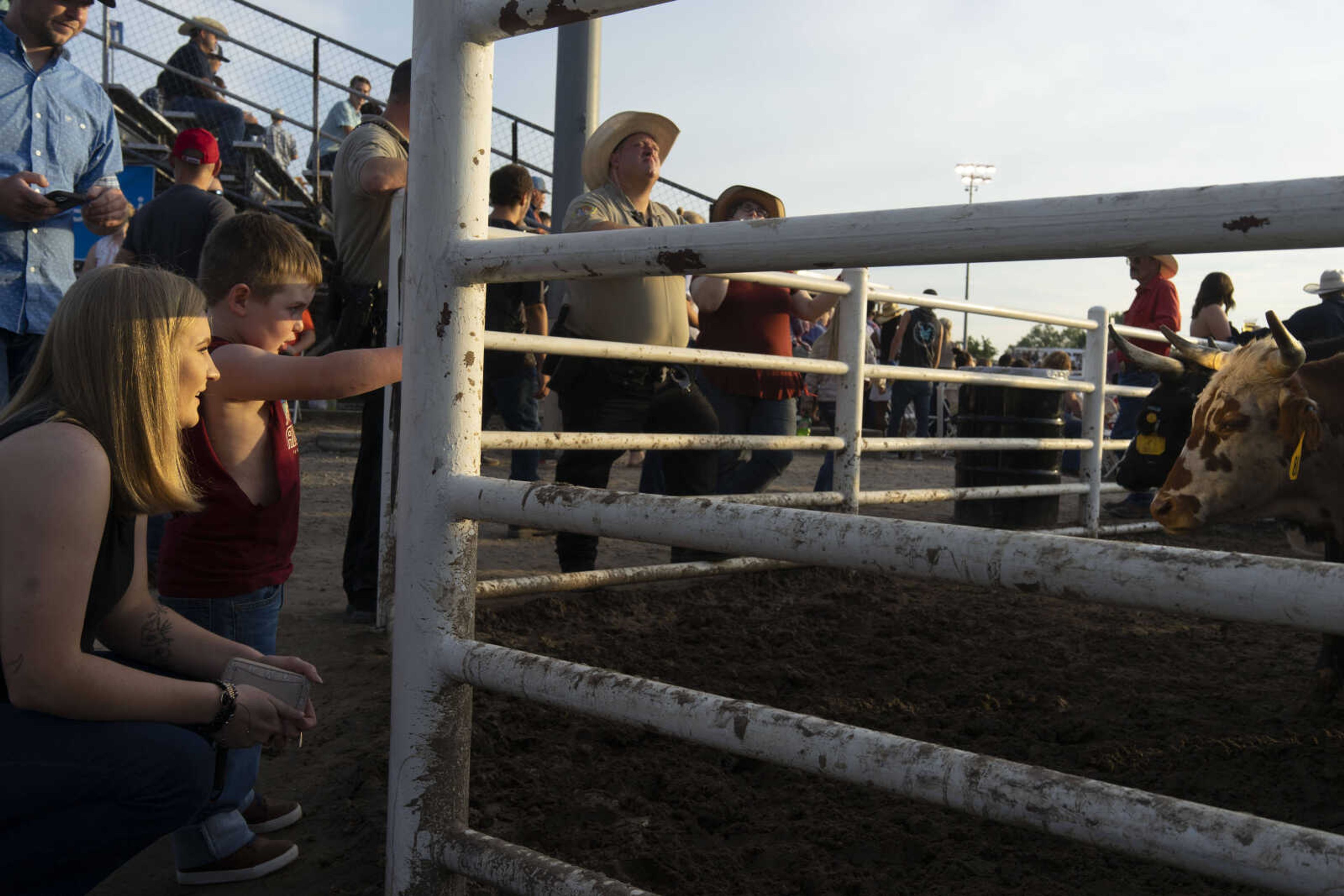 Liam Law, 3, points out livestock to his stepmother, Mady Dillow during the last night of the Sikeston Jaycee Bootheel Rodeo Saturday, Aug. 14, 2021,&nbsp;in Sikeston, Missouri.