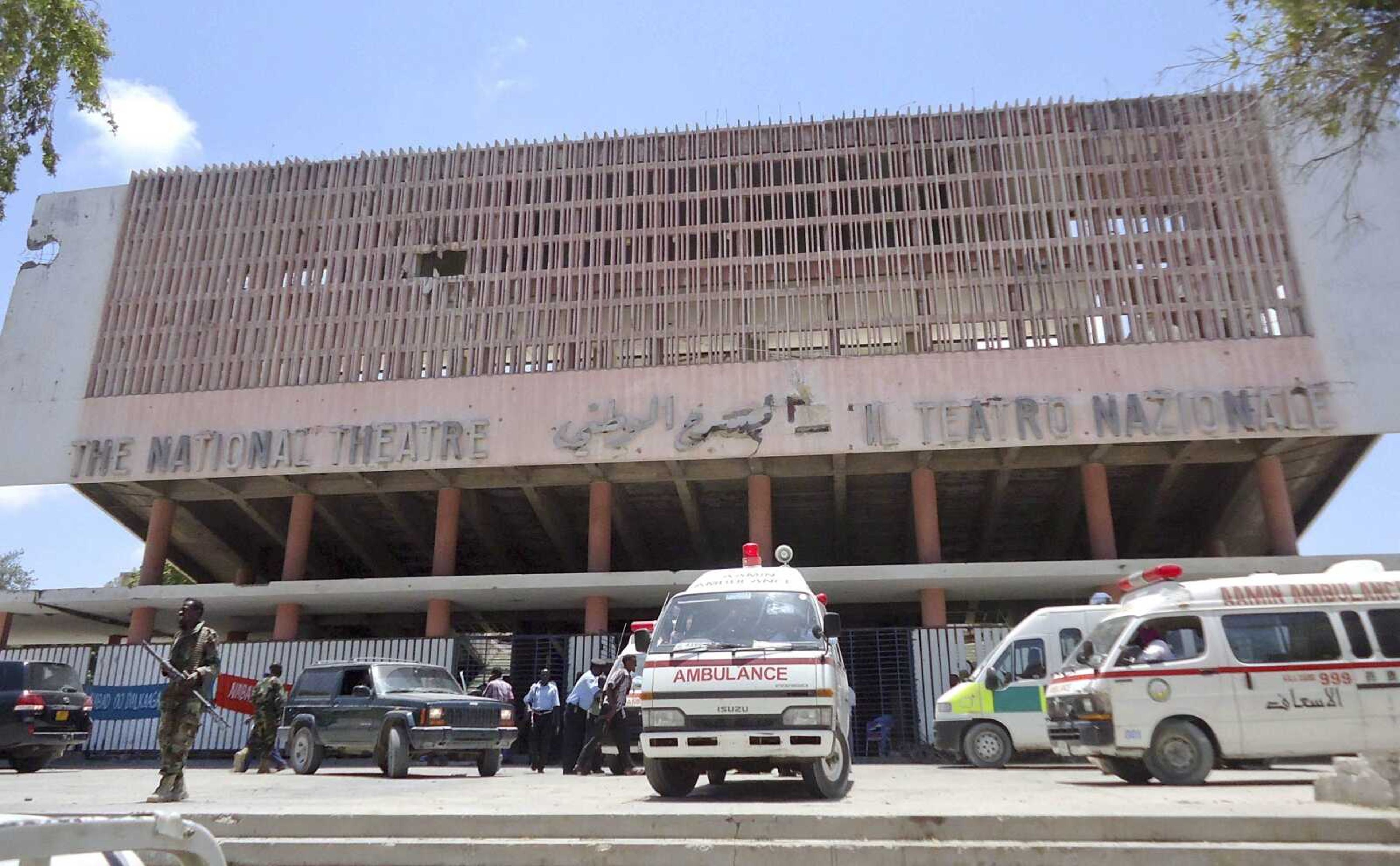 Ambulances stand outside the Somali National Theater on Wednesday in Mogadishu, Somalia. An explosion Wednesday at a ceremony at Somalia&#8217;s national theater killed at least 10 people, including two top sports officials in an attack by an Islamist group on a site that symbolized the city&#8217;s attempt to rise from two decades of war. (Farah Abdi Warsameh ~ Associated Press)