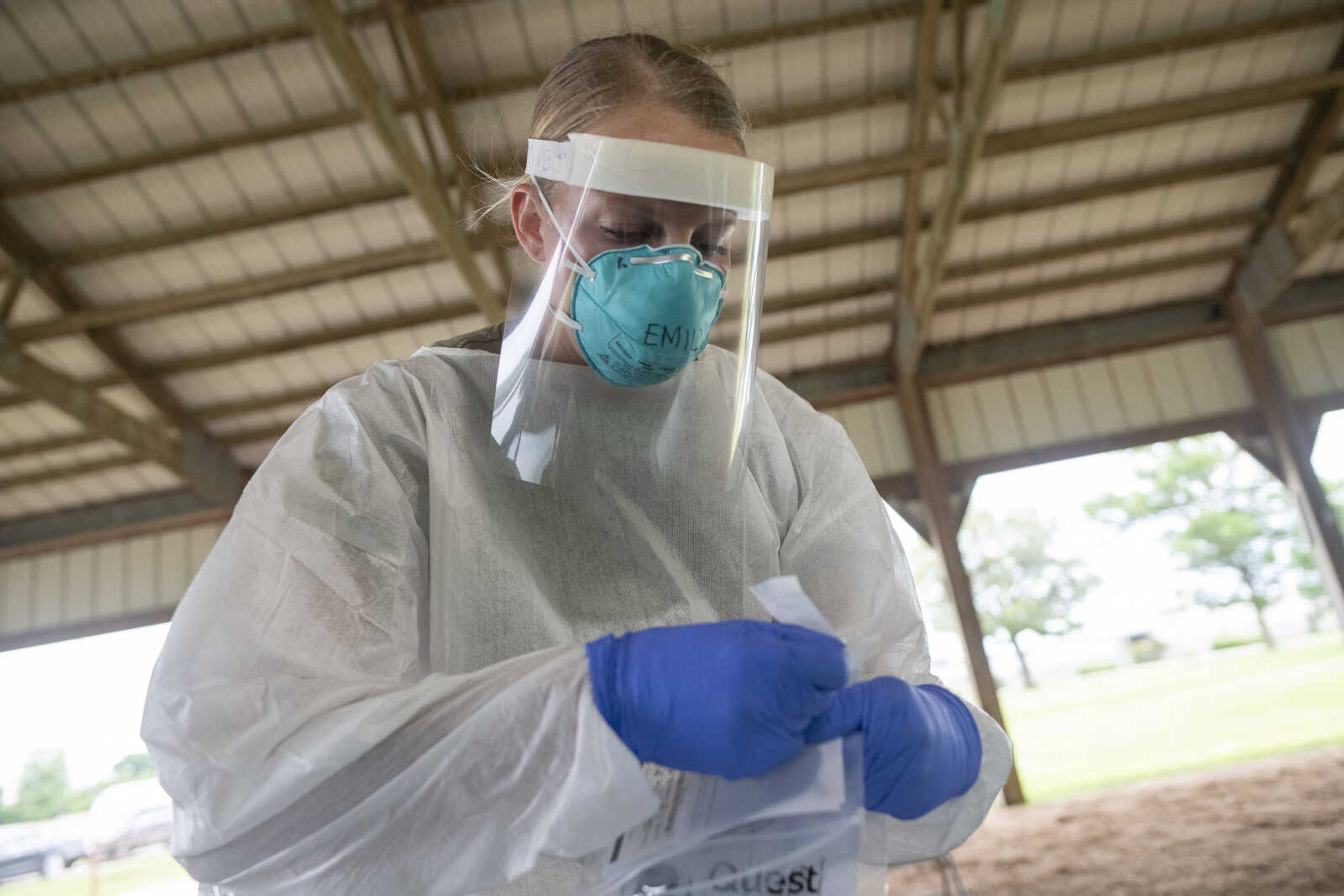 Army National Guard specialist Emily Davidson collects a nasal swab sample from Southeast Missourian photo editor Jacob Wiegand during a free COVID-19 testing Friday, June 5, 2020, at Arena Park in Cape Girardeau. The drive-through testing event was scheduled for 7 a.m. to 7 p.m.