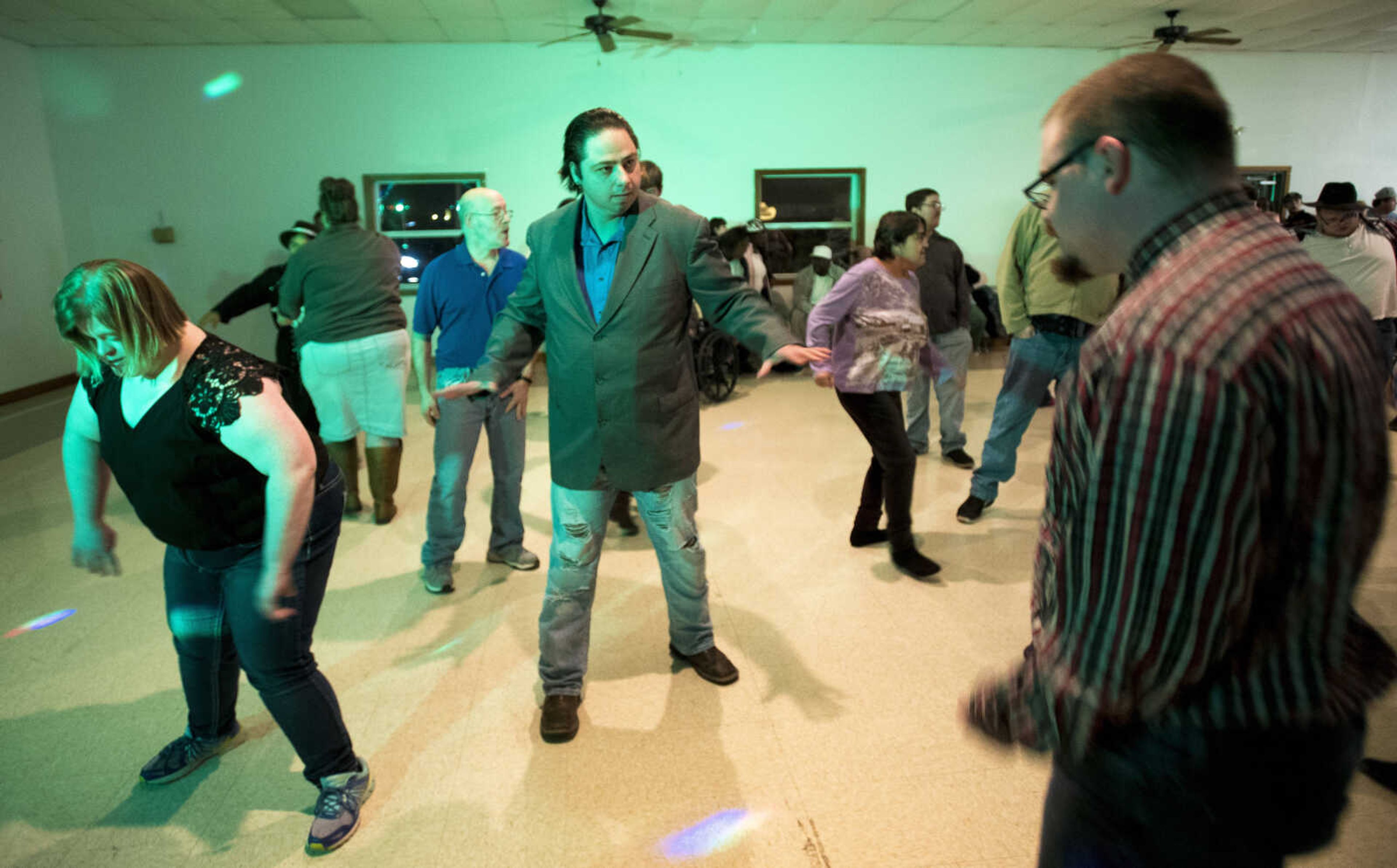 People dance during the S.T.A.R. Barnyard Dance in the 4-H Building at Arena Park Thursday, Nov. 16, 2017 in Cape Girardeau.