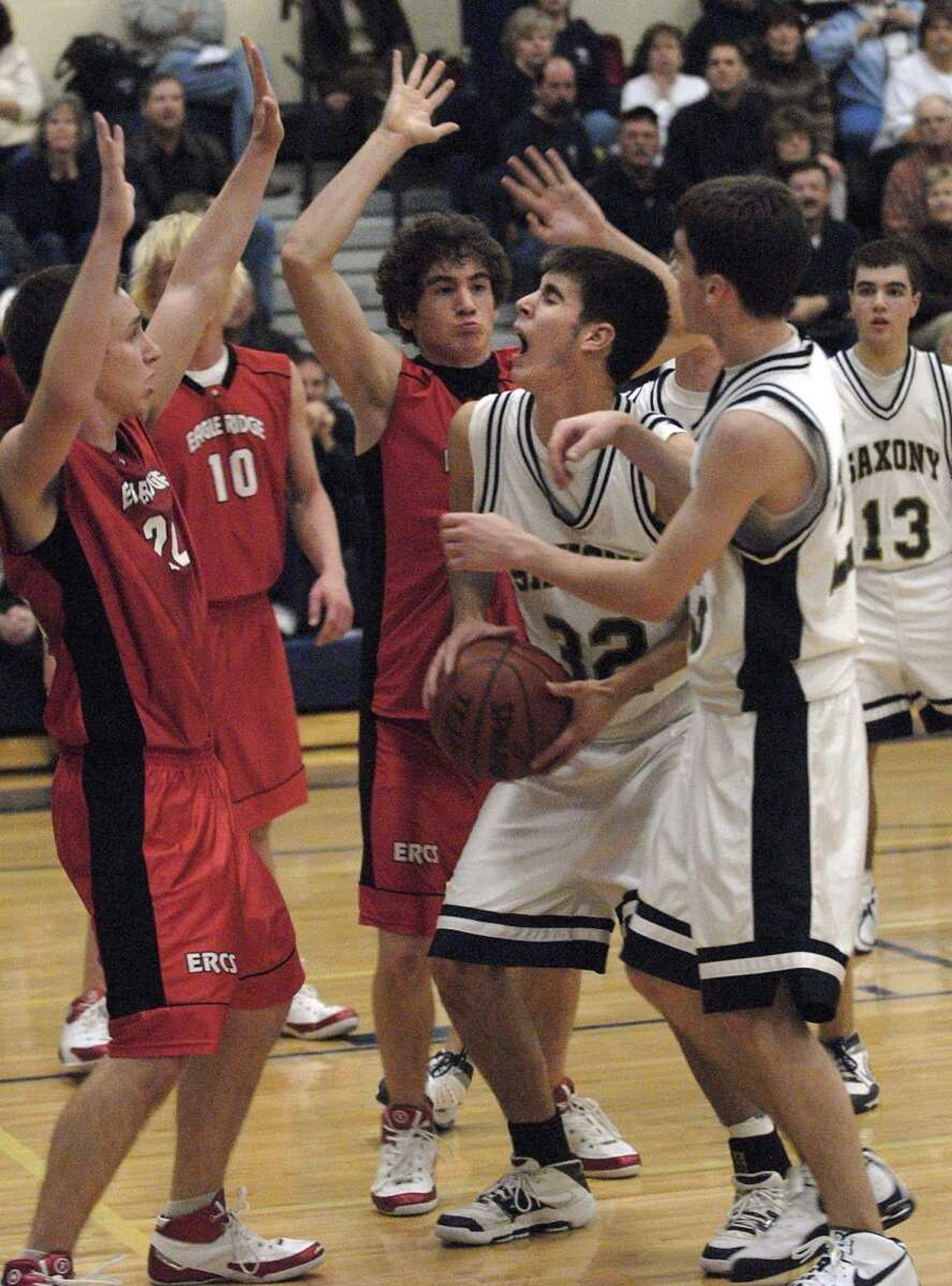 FRED LYNCH ~ flynch@semissourian.com<br>Saxony Lutheran's Bret Steffens prepares to shoot while defended by Eagle Ridge's Josh Wiseman, left, and Stephen Cohen in the second quarter Monday at Saxony Lutheran High School.