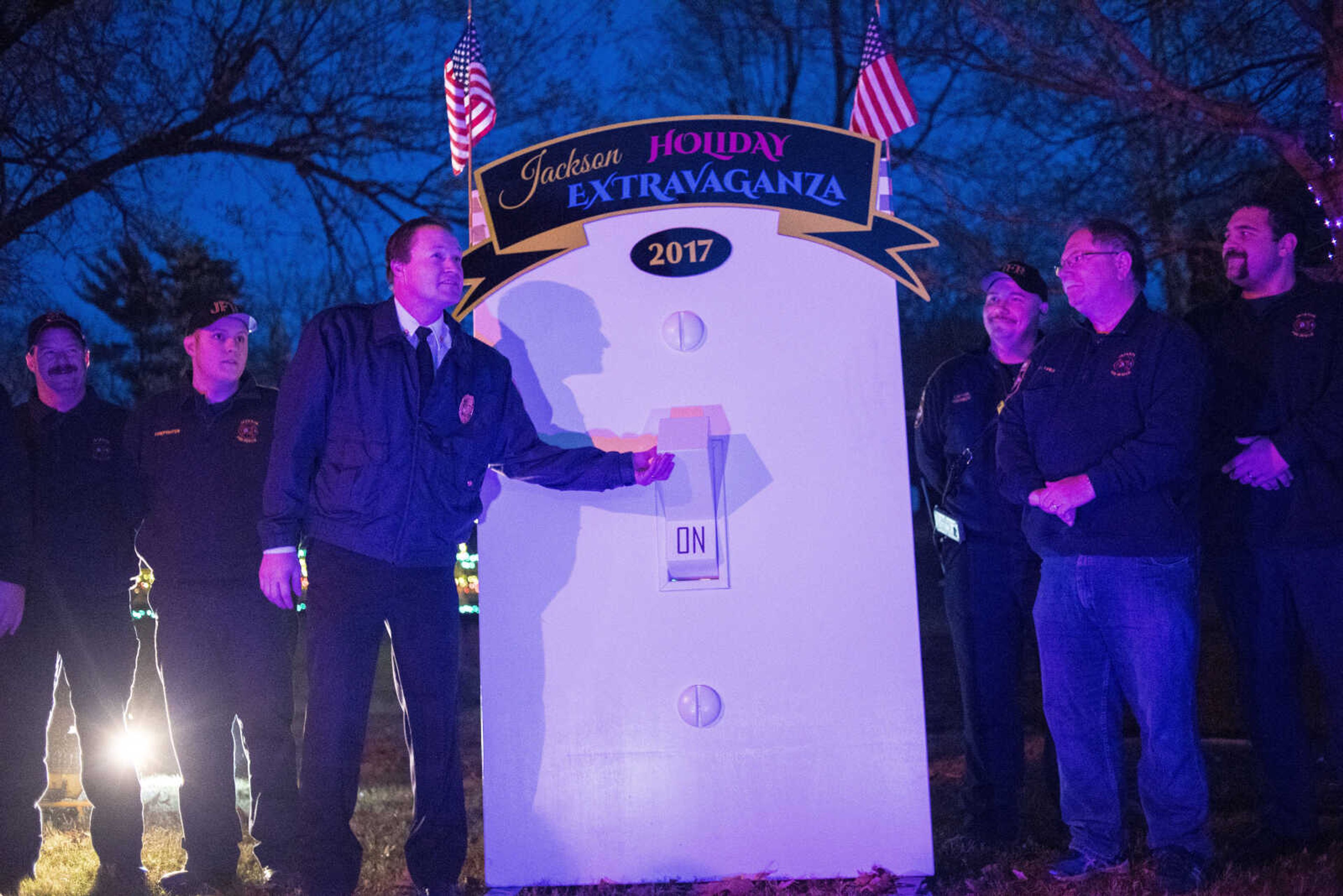 Jackson Fire Chief Jason Mouser flips the switch during the Jackson Holiday Extravaganza Friday, Nov. 24, 2017 at the Jackson City Park.