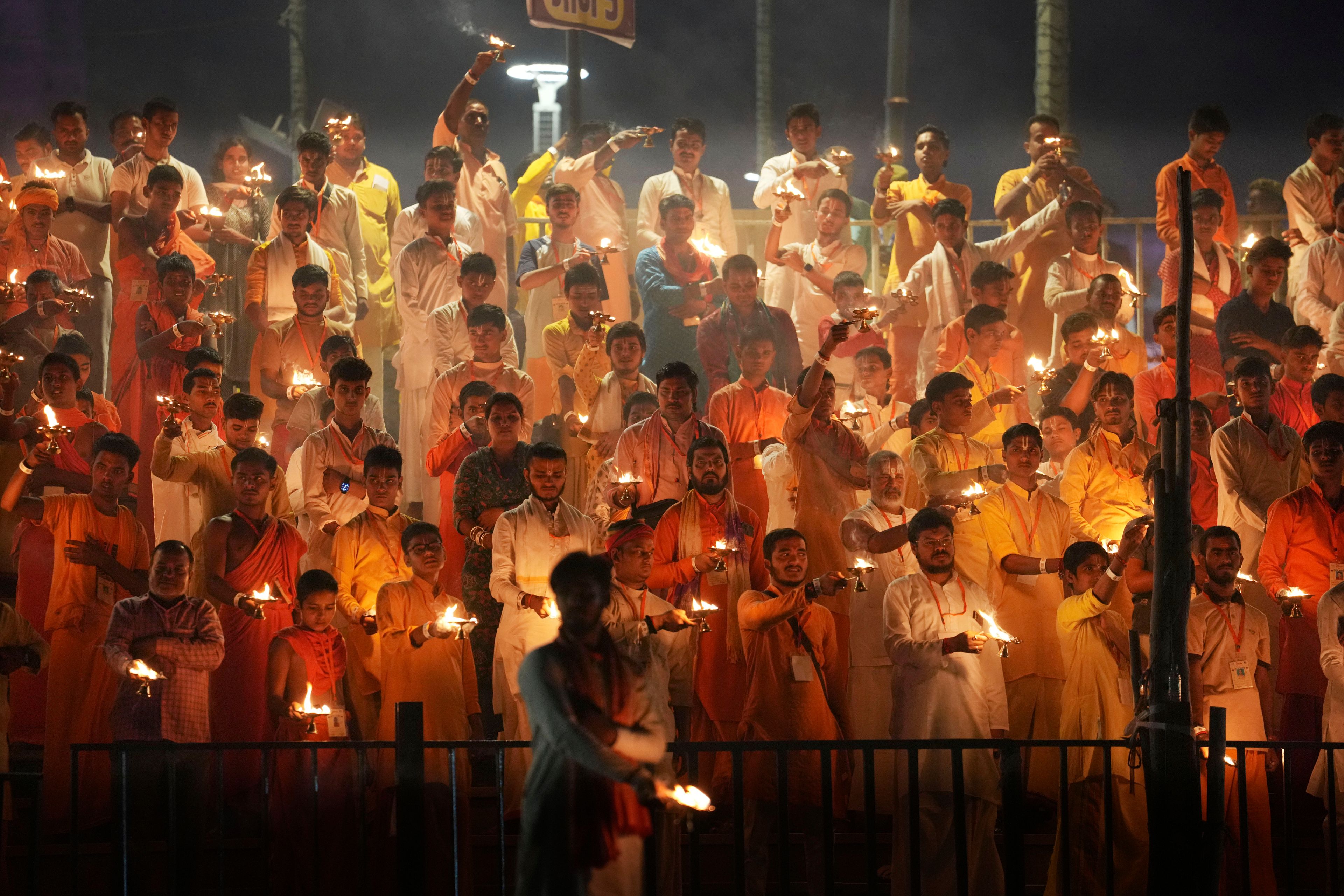 Hindu priests carry lamps as they pray on the banks of the Saryu river during Deepotsav celebrations, an event organized by the Uttar Pradesh state government on the eve of Diwali, in Ayodhya, India, Wednesday, Oct. 30, 2024. (AP Photo/Rajesh Kumar Singh)