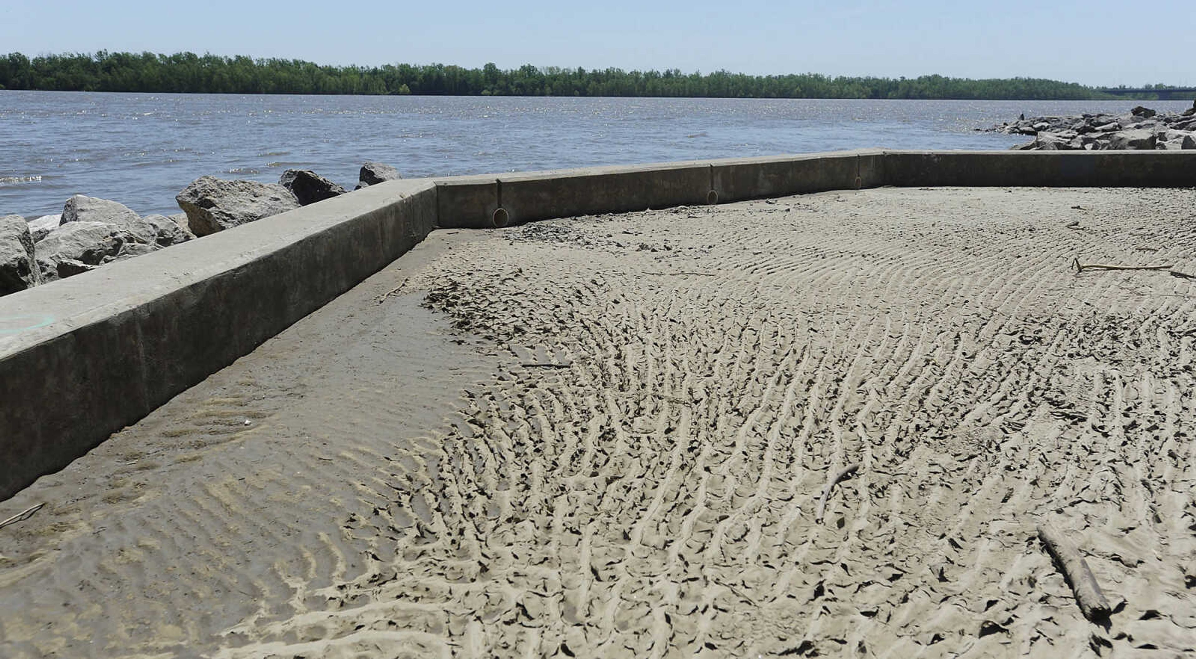 Dirt and mud coat the walking path at Riverfront Park Wednesday, May 15, in Cape Girardeau. The Broadway floodgate has been opened but the floodgate at Themis Street remains closed.