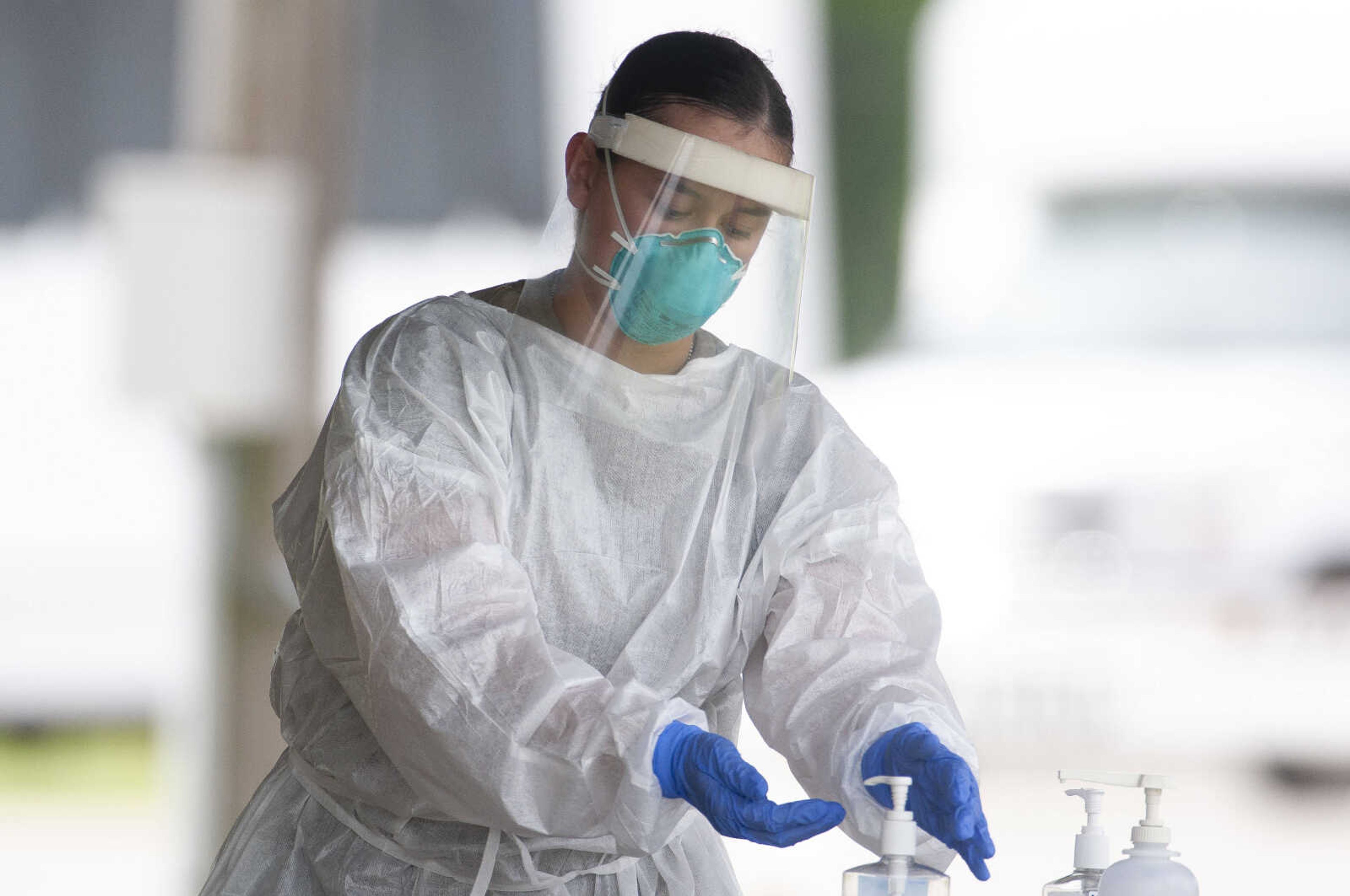 Kristen Arroyo, a private first class with the Missouri Army National Guard, works in personal protective equipment during free COVID-19 testing Friday, June 5, 2020, at Arena Park in Cape Girardeau. The drive-through testing event was scheduled for 7 a.m. to 7 p.m.