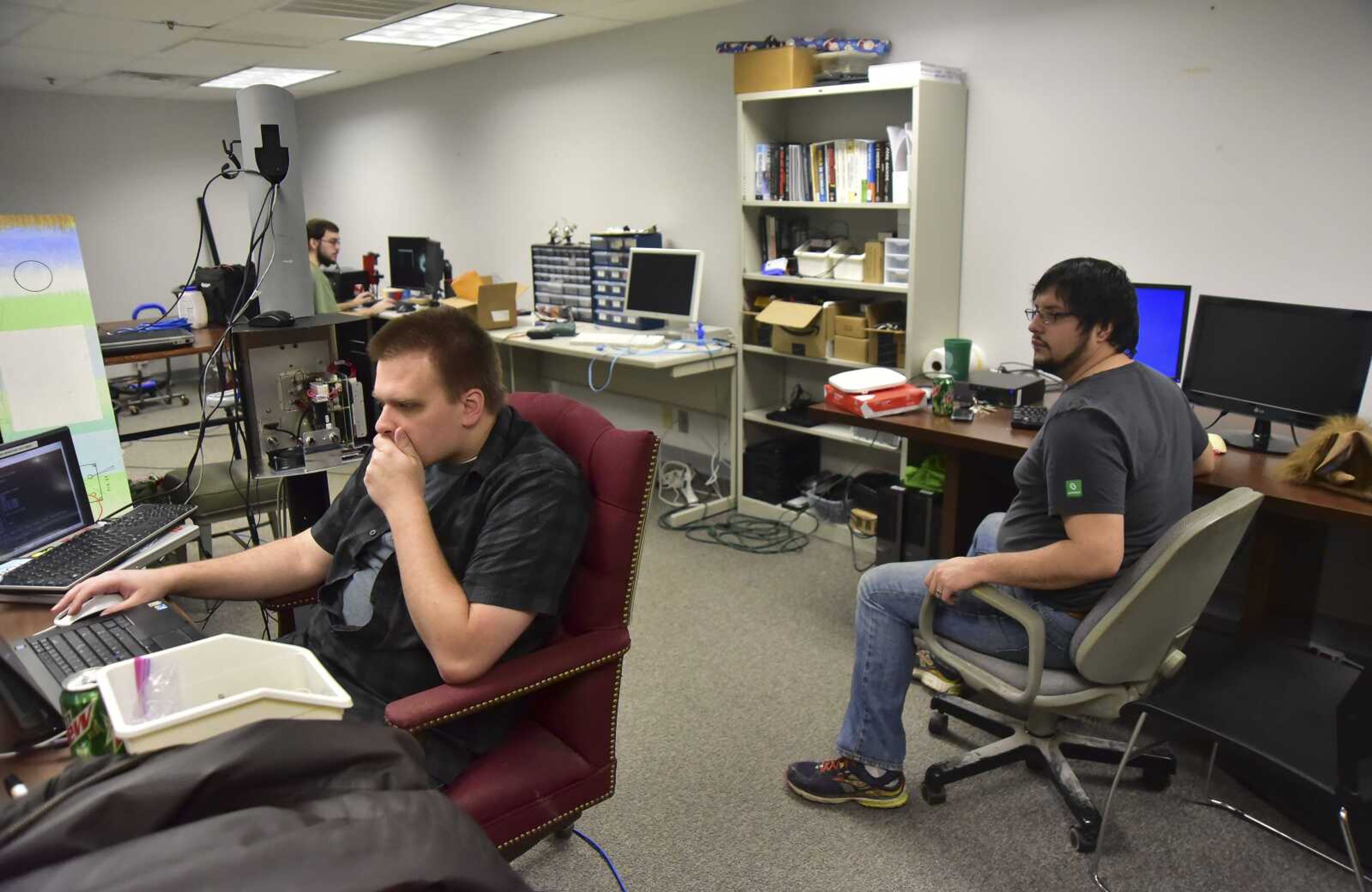 Kirk Tolleshaug, left, and Charlie Wallgren work in their office of Cape Crucible in the basement of the old federal building Wednesday in Cape Girardeau. Cape Crucible allows people to come in and use equipment not readily available to the public, such as 3-D printers, woodworking and soldering tools.