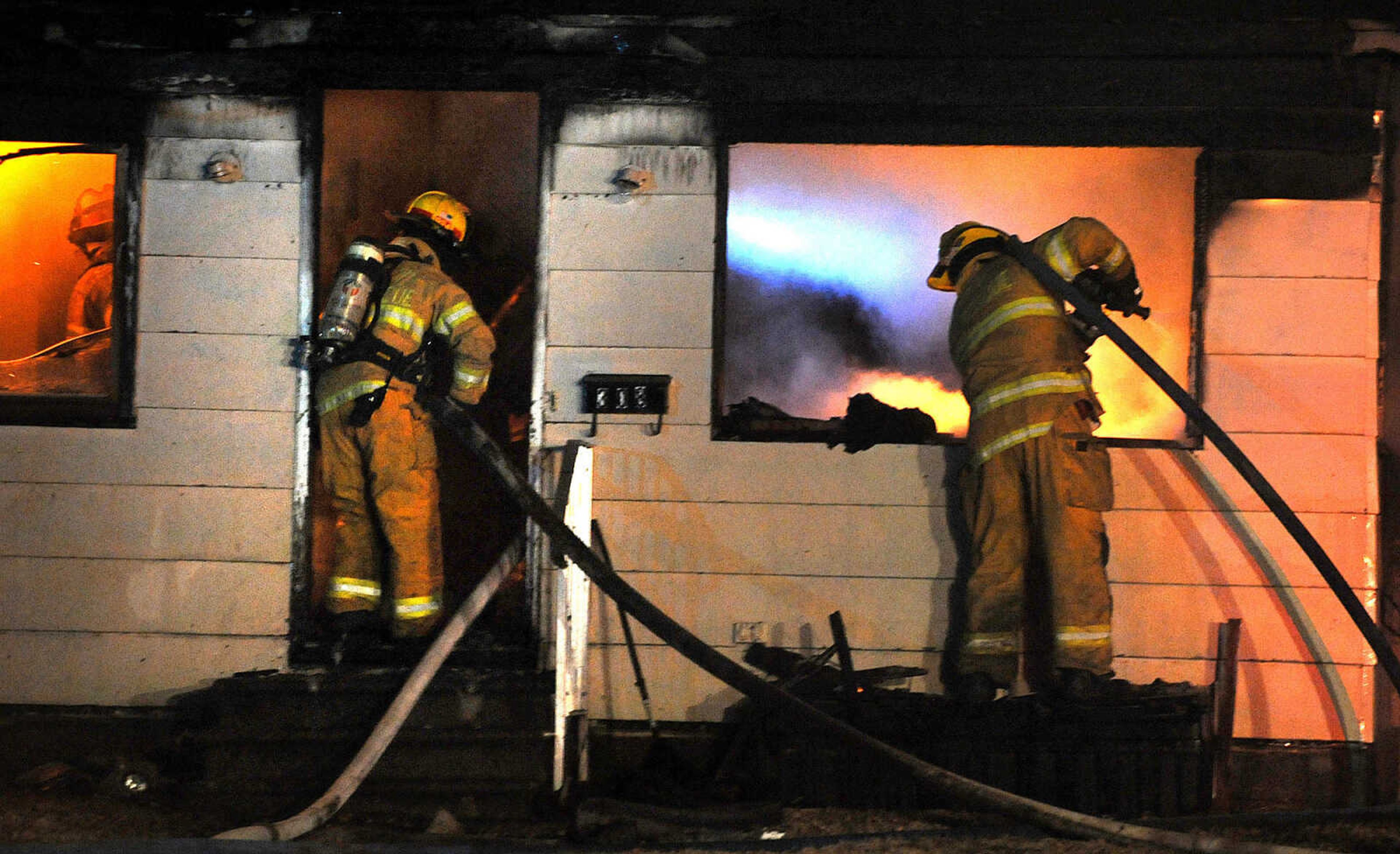 LAURA SIMON ~ lsimon@semissourian.com

Members of the Scott City and Cape Girardeau fire departments battle a blaze at 308 W. Missouri Blvd. in Scott City, Wednesday, Dec. 18, 2013. Nobody was injured in the fire.