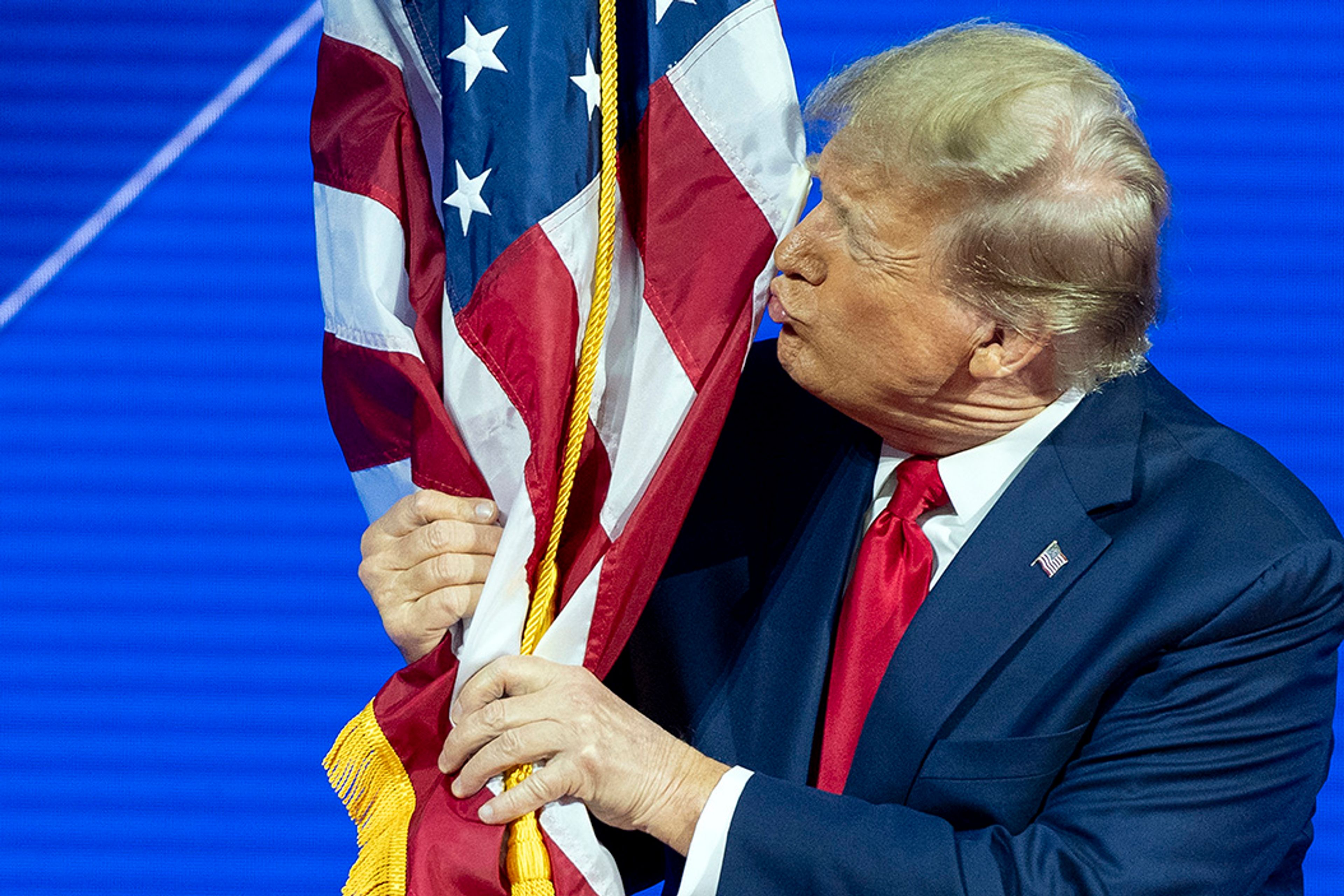 Republican presidential candidate former President Donald Trump kisses the flag as arrives to speak during the Conservative Political Action Conference, CPAC 2024, at National Harbor, in Oxon Hill, Md., Saturday, Feb. 24, 2024.