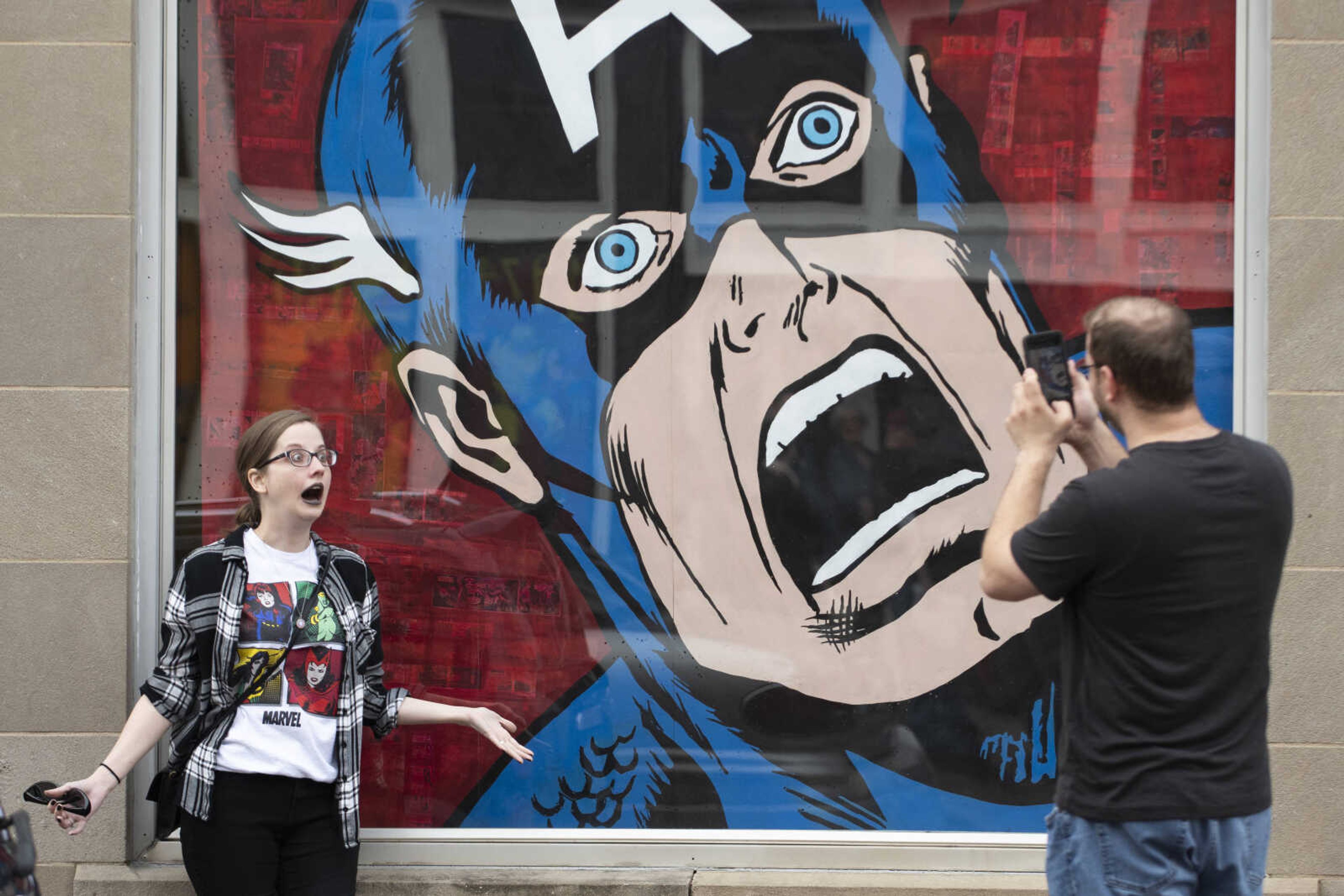 Carrie Walker has her picture taken by Justin Dambach, both from Jackson and now living in Cape Girardeau, next to a picture of Marvel Comics character Captain America on Saturday, Feb. 23, 2019, on High Street in Jackson. On Saturday, former editor-in-chief of Marvel Comics, co-creator of the character Wolverine and Jackson native Roy Thomas met with fans at the Cape Girardeau County History Center in Jackson.