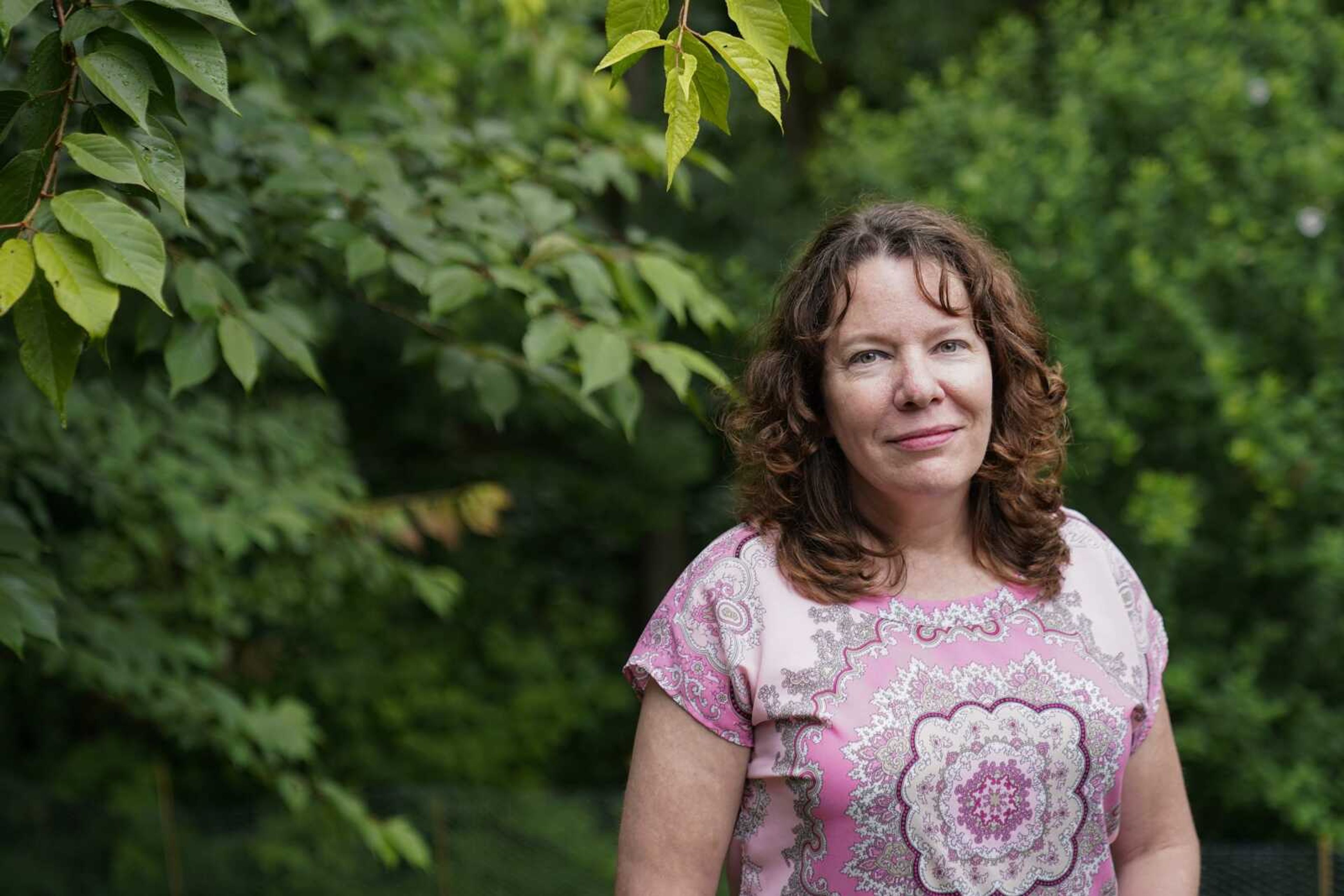 Julie Akey stands for a portrait in her backyard June 22, 2021, in Herndon, Virginia. Akey, a U.S. Army veteran who had lived at Fort Ord in California and was diagnosed in 2016 at the age of 46 with multiple myeloma, a rare blood cancer, said she is "confident that science will prove our high rate of cancers and illnesses are not a coincidence." Akey started a Facebook group for Fort Ord veterans suffering from cancers; the number of members has swelled to nearly 1,000.