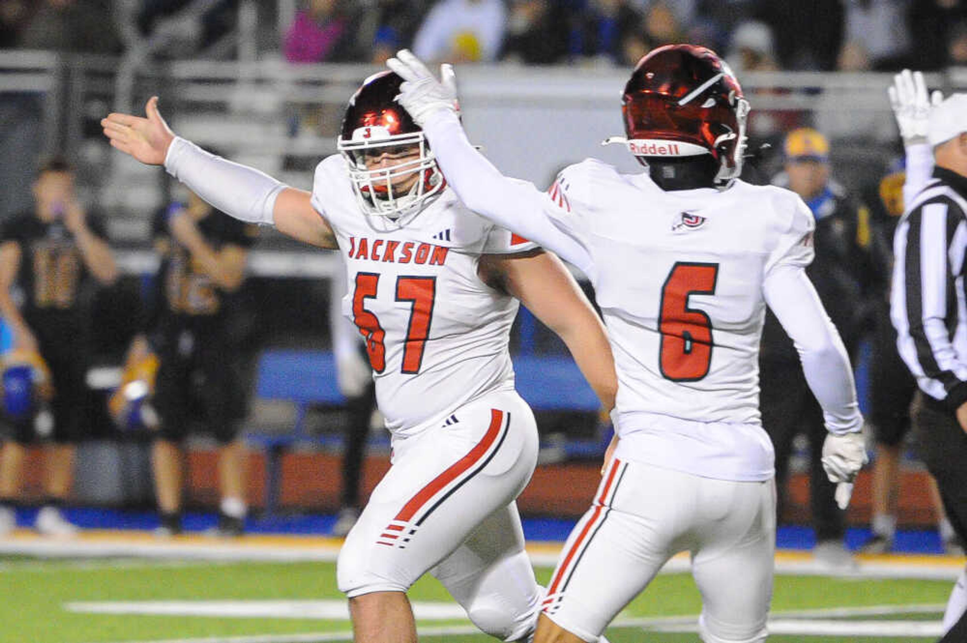 Jackson’s Marcus Cutsinger, left, celebrates a turnover during the Class 6 District 1 championship game between the Jackson Indians and the Seckman Jaguars on Friday, Nov. 15, at Seckman High School in Imperial.