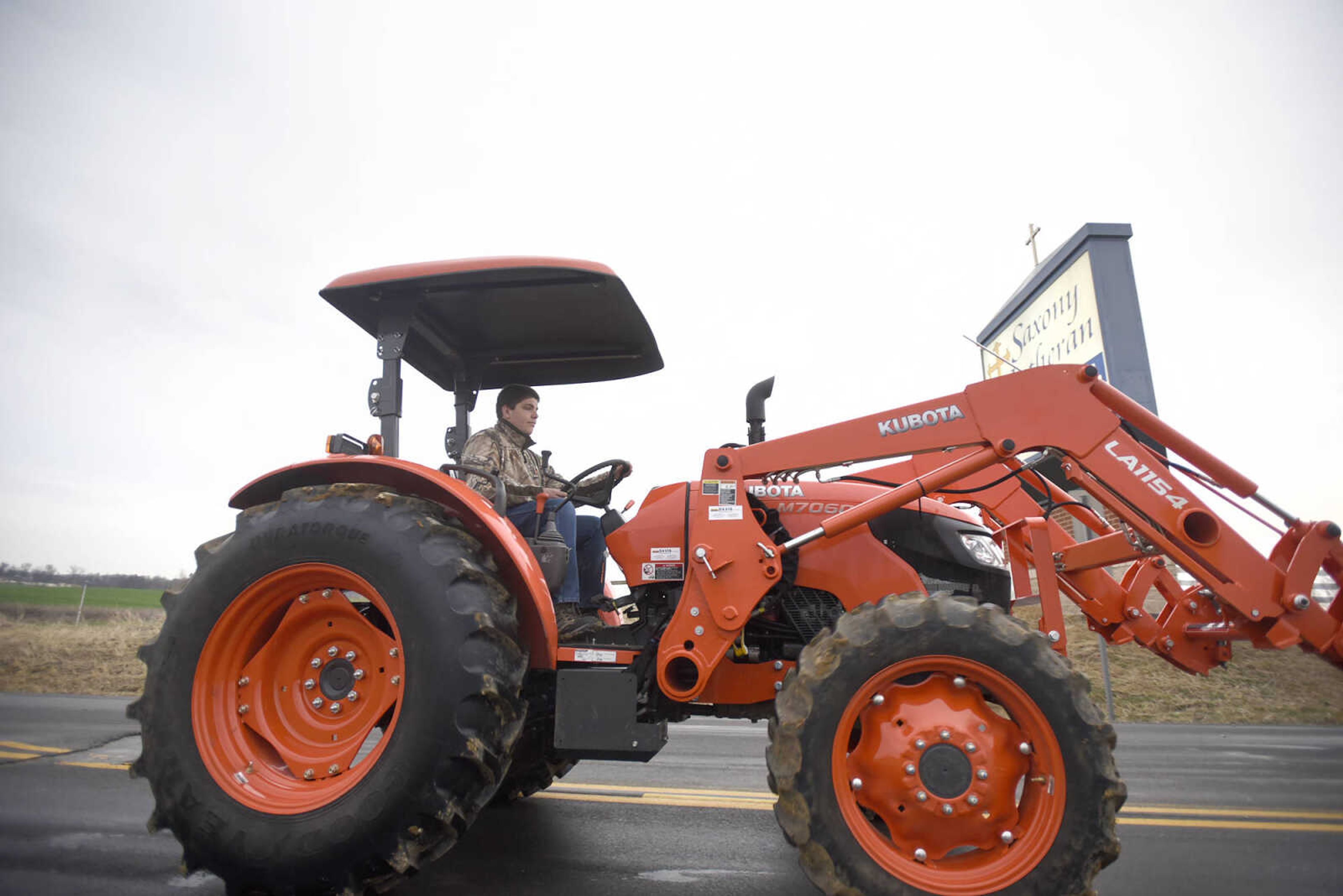 Saxony Lutheran High School FFA students take to the road on their tractors during drive your tractor to school day on Tuesday morning, Feb. 21, 2017. Students began their journey to school from Davis Farm Supply on Highway 61 in Jackson as part of FFA Week.