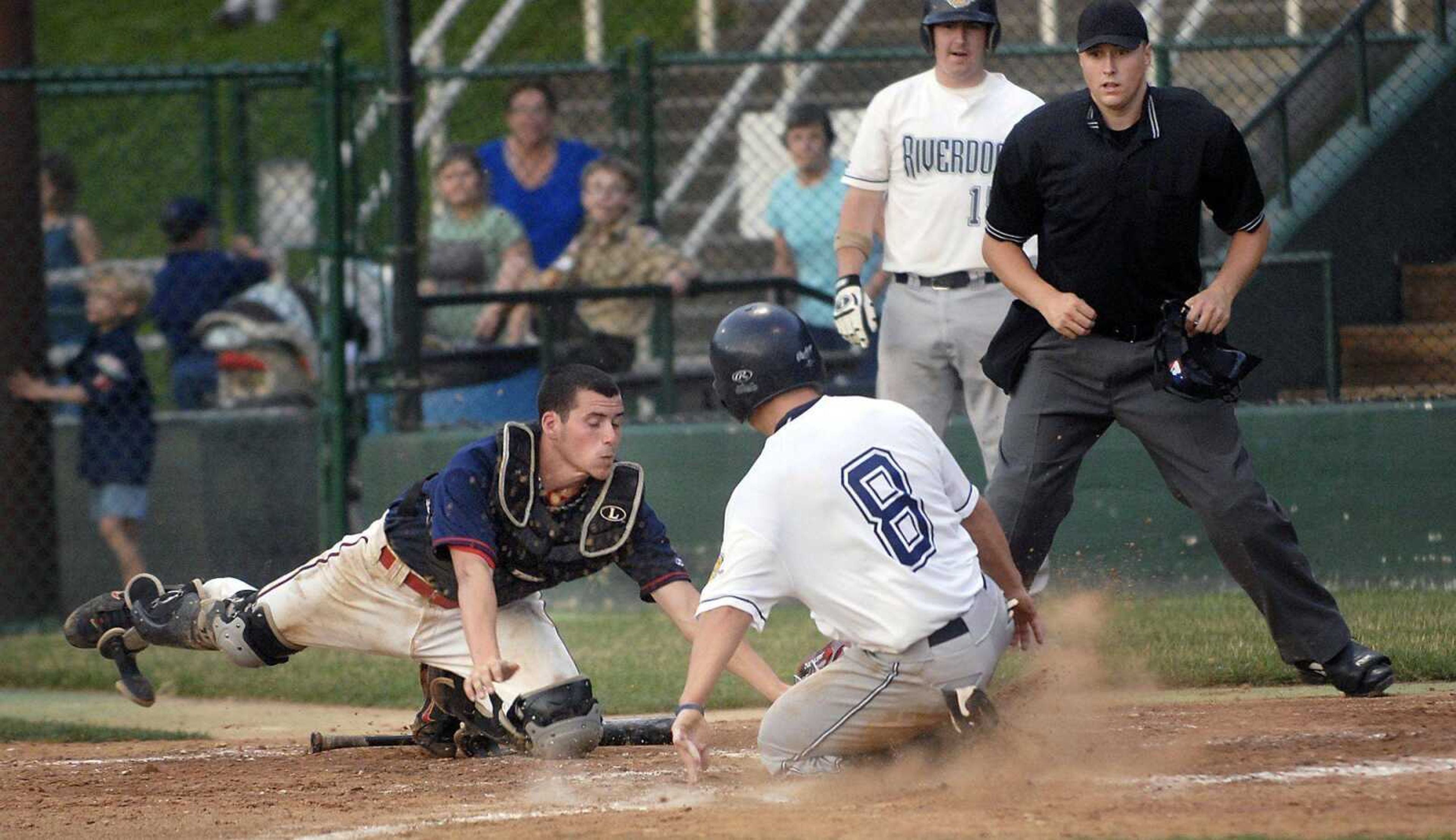 Riverdogs baserunner Caleb Daughhetee scores Friday as he beats the tag by Capahas catcher Drew Pixley.