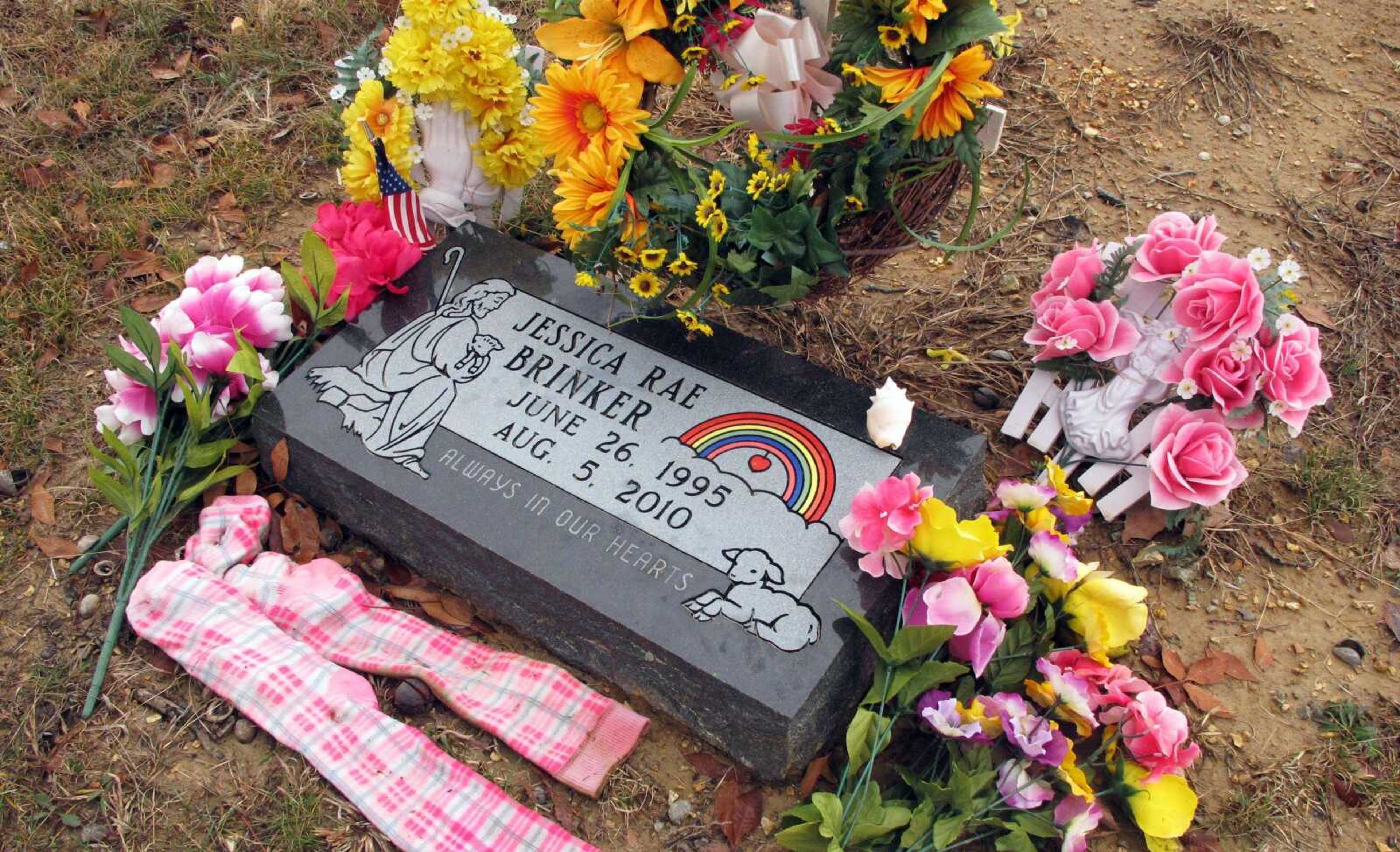 Bright knee-high socks and wreaths of flowers adorn Jessica Brinker&#8217;s headstone Thursday at a Catholic cemetery in St. James, Mo. Brinker was 15 when she was killed in August 2010 when the bus on which she was riding with fellow members of her high school&#8217;s marching band was involved in a pileup accident investigators say began with a pickup truck&#8217;s driver who had been texting behind the wheel. (Jim Suhr ~ Associated Press)