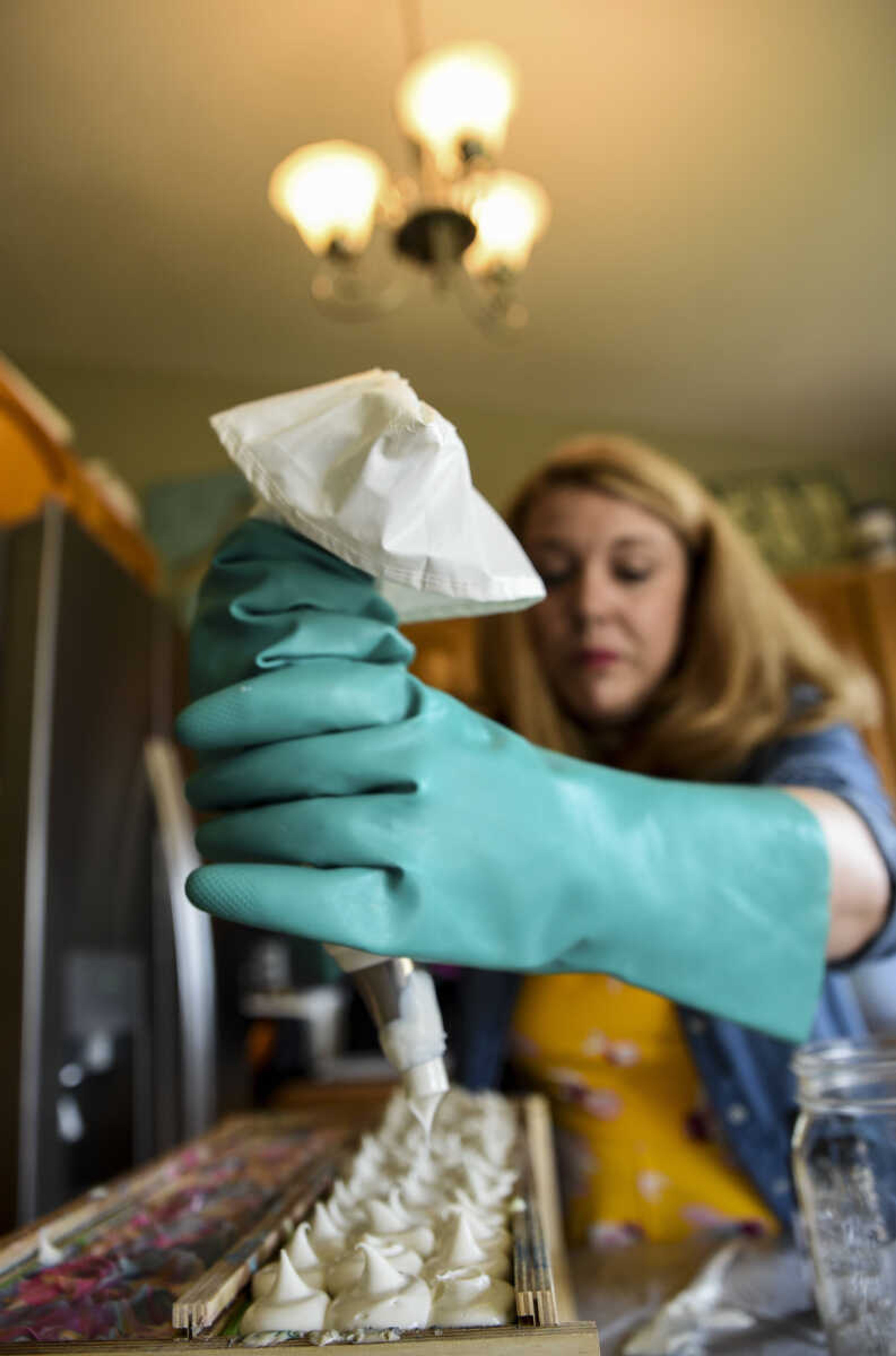 Breanna Stone puts the finishing touches on her soap "Happy Apple" as part of her soap-making process in her home Tuesday, May 1, 2018, in Jackson.