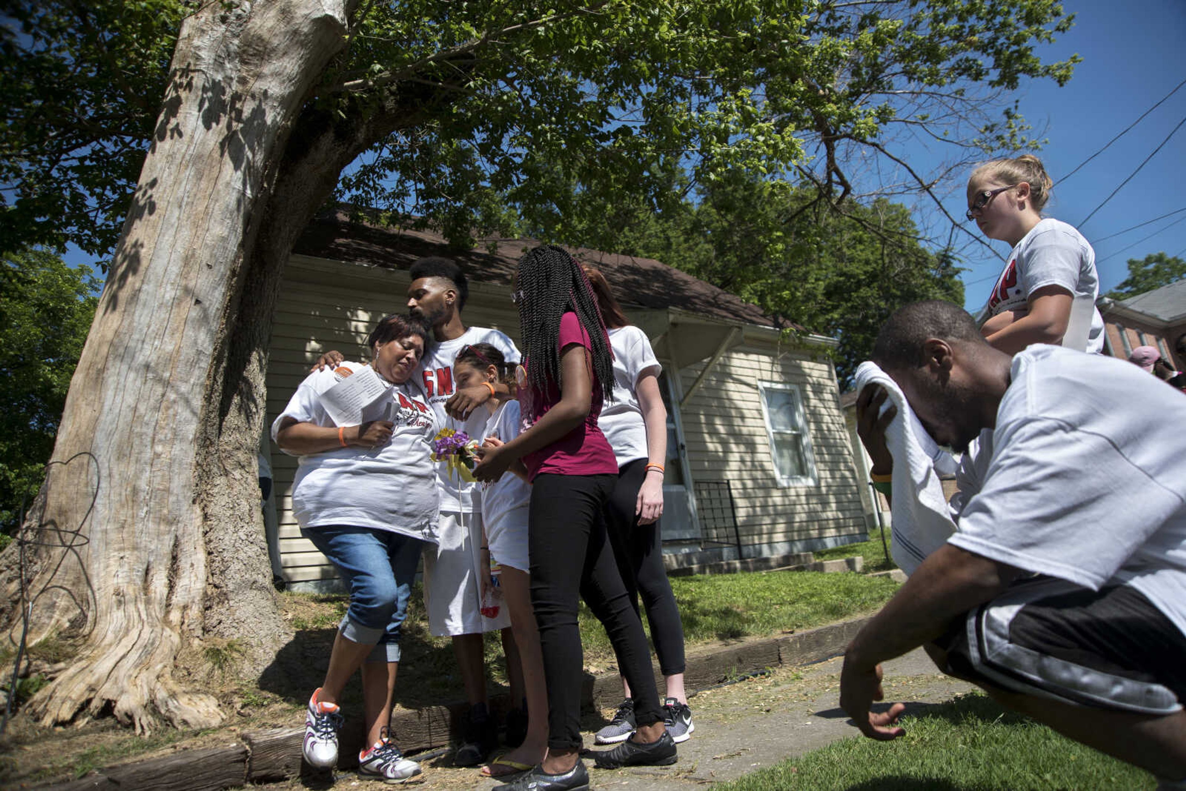 Felice Roberson, left, is kissed by her son Willie Brown while a prayer is said for her son Quinton Combs who was shot and killed in 2015 during a Stop Needless Acts of Violence Please (SNAP) prayer march Saturday, June 10, 2017 in Cape Girardeau. Over 50 people including members of SNAP, Community Counseling Center, Moms Demand Action for Gun Sense in America and public safety officials came out for the second prayer march. Community members then walked down the streets from Indian Park to Ranney Park stopping at each location of those who have died to violence. 'If I can just help one person it's not going to be in vain." Roberson said.