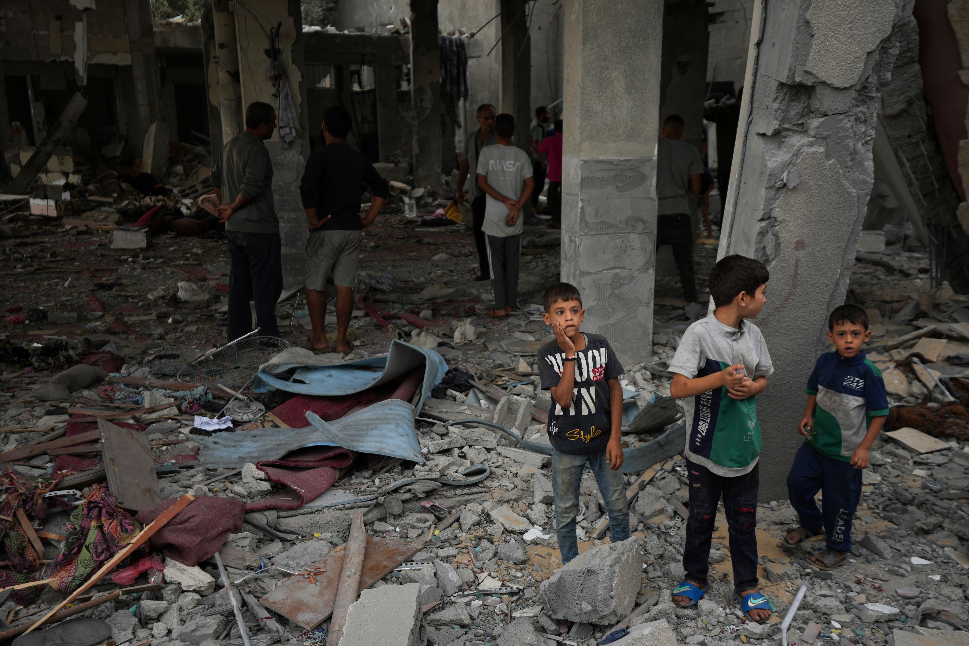 Palestinians examine a destroyed mosque following an Israeli airstrike in Deir al-Balah, Sunday, Oct. 6, 2024. (AP Photo/Abdel Kareem Hana)