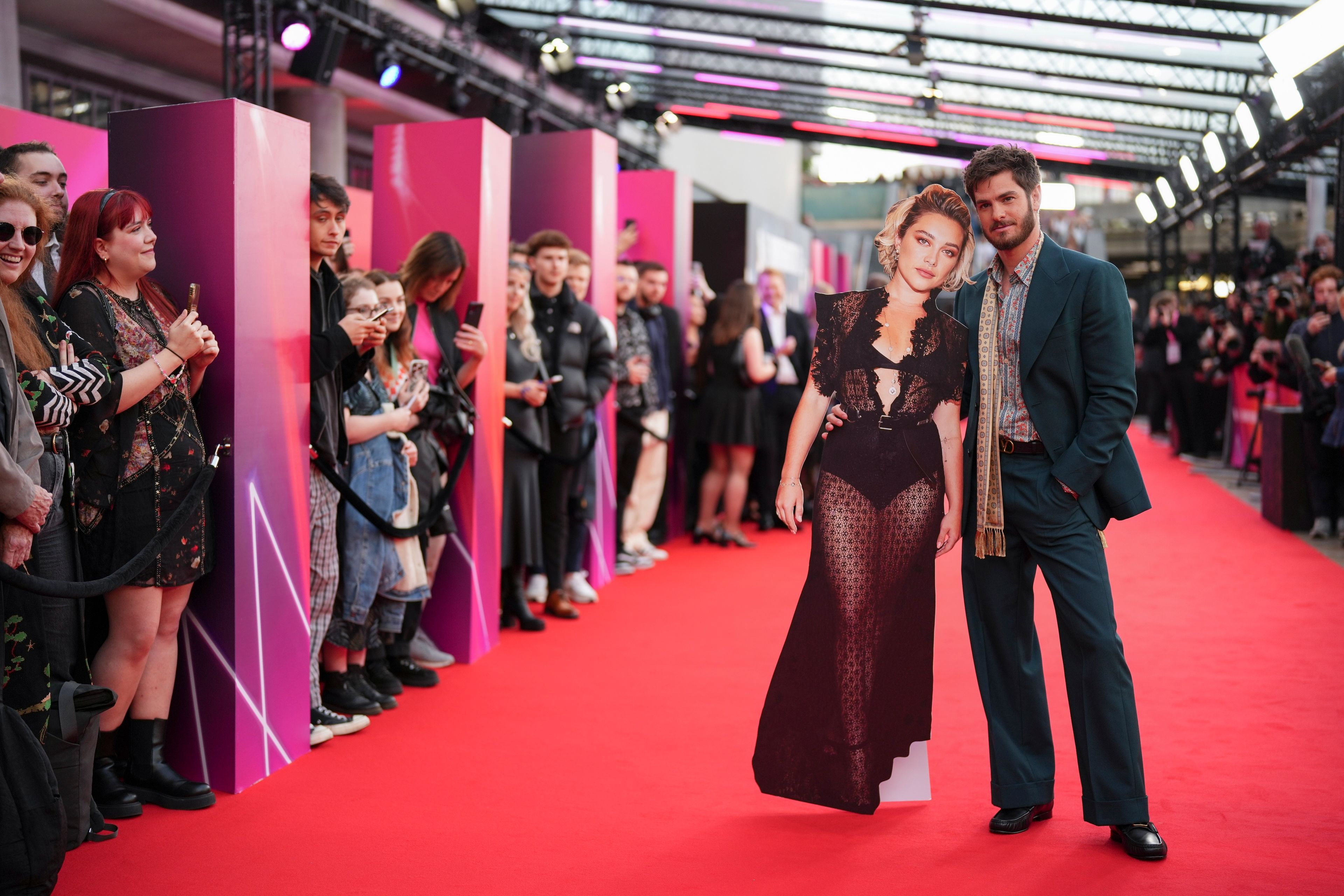 Andrew Garfield poses with a cut out of fellow actor Florence Pugh upon arrival at the premiere for the film 'We Live In Time' on Thursday, Oct. 17, 2024, in London. (Photo by Scott A Garfitt/Invision/AP)