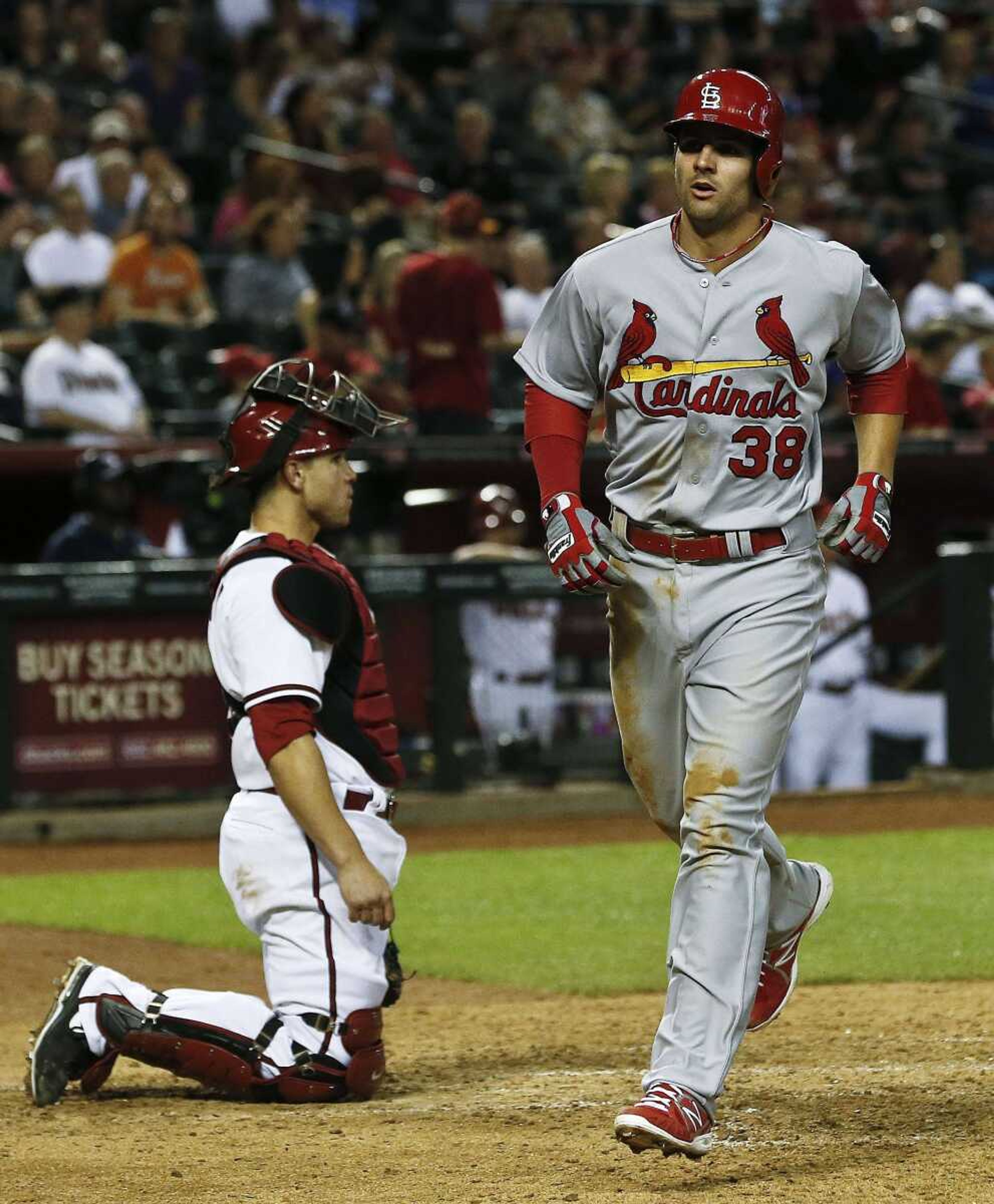 The Cardinals&#8217; Pete Kozma runs past Diamondbacks catcher Miguel Montero after hitting a home run during the seventh inning Tuesday in Phoenix. The Cardinals won 6-1. (Ross D. Franklin ~ Associated Press)