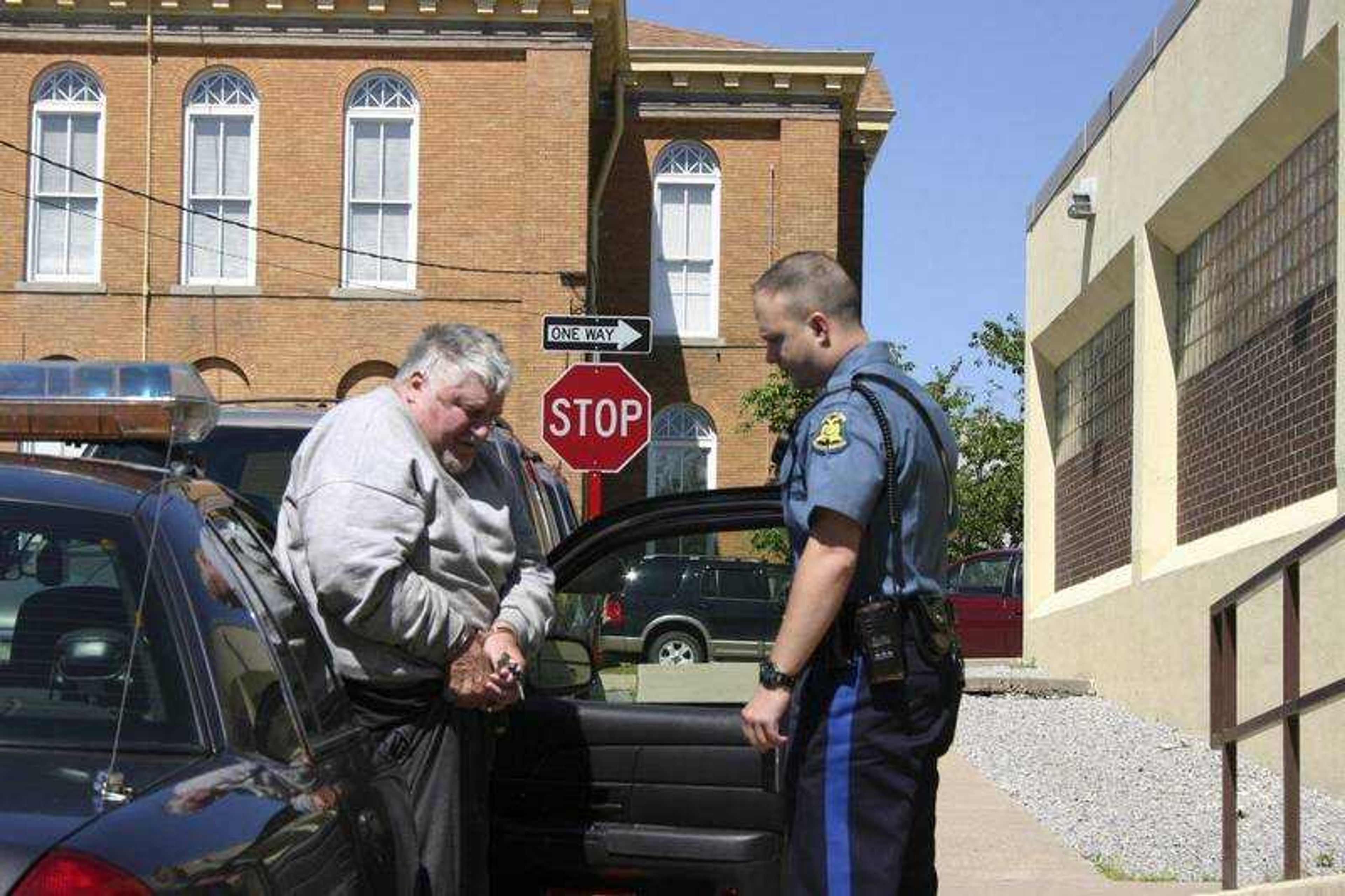 COREY NOLES ~ Dexter Daily Statesman
Robert Pink, arrested in Friday's countywide drug bust, stepped out of a highway patrolman's car to be escorted into the Stoddard County Jail.