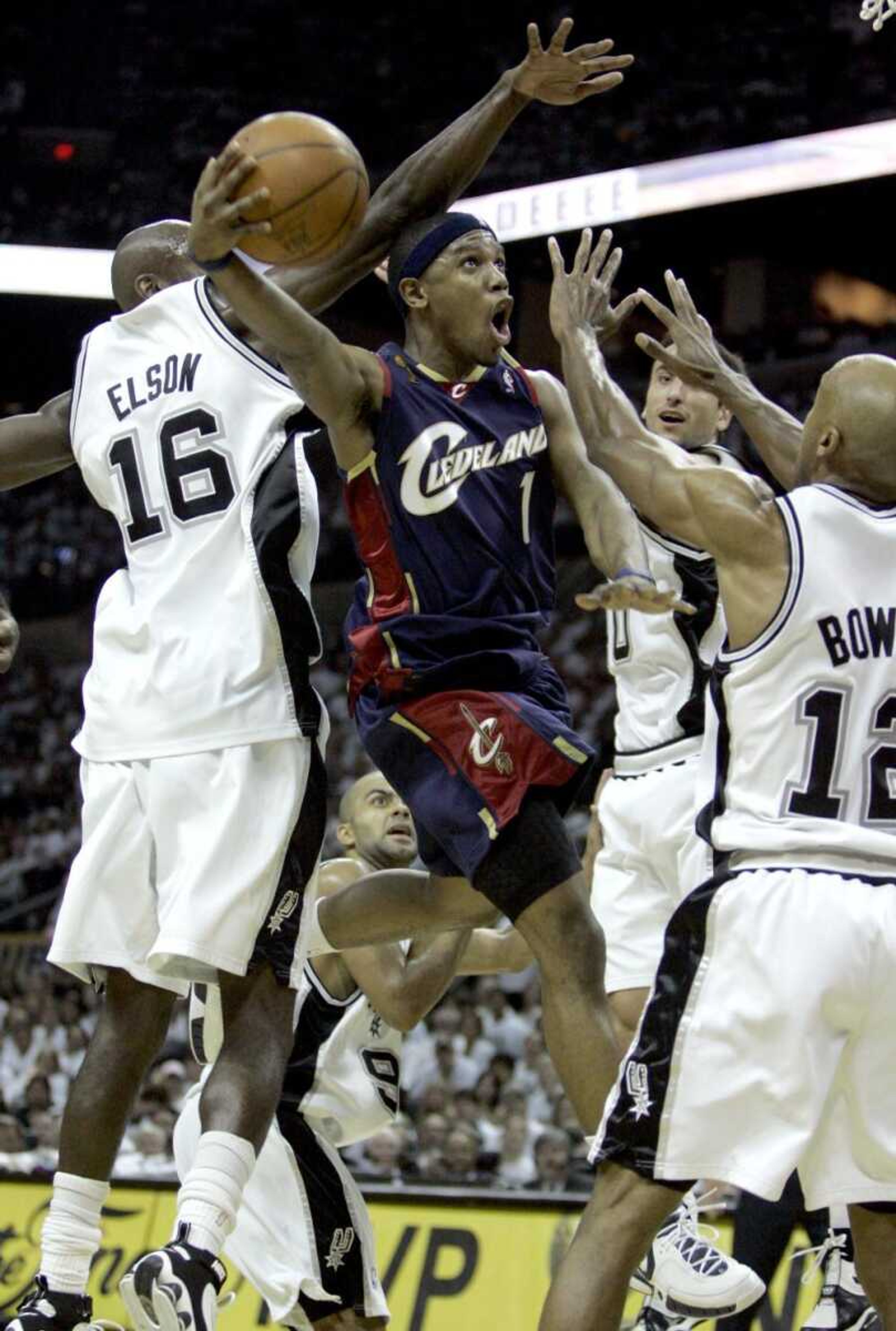 Cleveland Cavaliers guard Daniel Gibson (1) shot between the San Antonio Spurs' Francisco Elson (16), Bruce Bowen (12) and Manu Ginobili during Thursday's Game 1 of the NBA finals in San Antonio. The Spurs won 85-76. (TONY DEJAK ~ Associated Press)