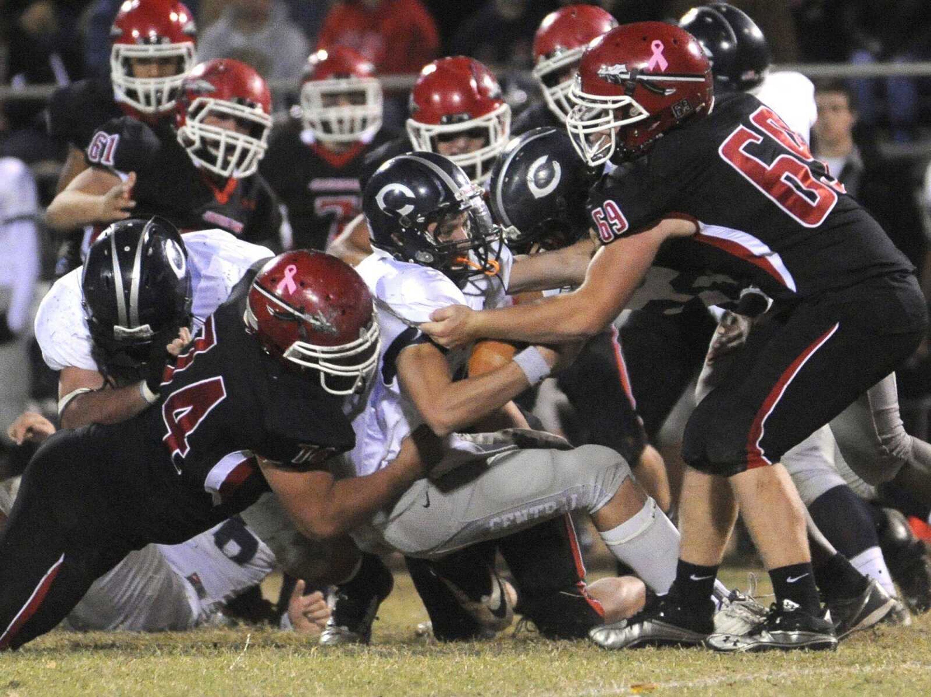 Francis Howell Central quarterback Brody Allen runs into a wall of Jackson defenders, including Preston Hobeck, left, and Garrett Koch, right, on fourth down during the second quarter Friday in Jackson. (Fred Lynch)