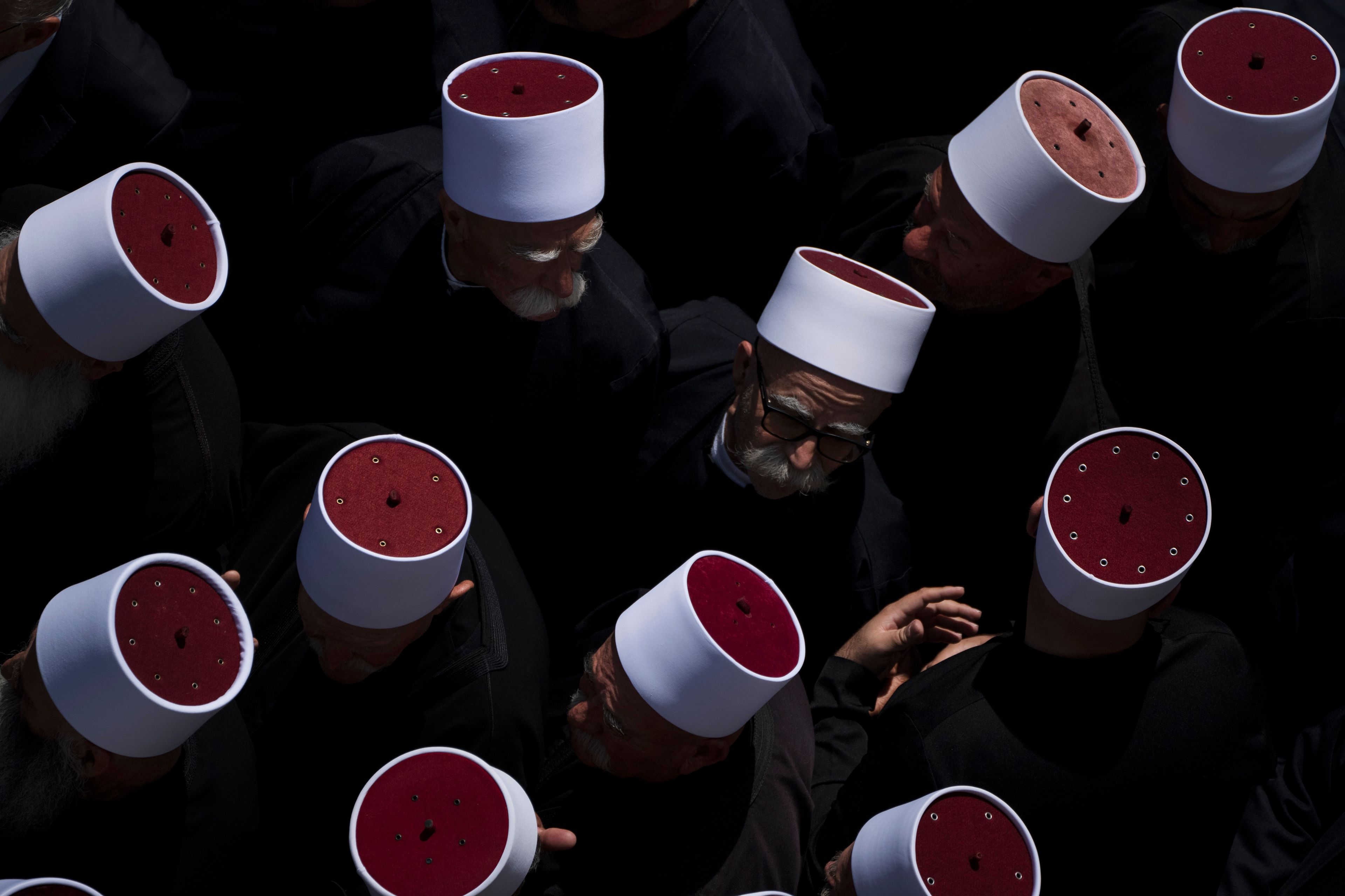 Druze clergymen attend the funeral of some of the 12 children and teens killed in a rocket strike at a soccer field at the village of Majdal Shams, in the Israeli-annexed Golan Heights, Sunday, July 28, 2024. It's the deadliest strike on an Israeli target along the country's northern border since the fighting between Israel and the Lebanese militant group Hezbollah began. (AP Photo/Leo Correa)