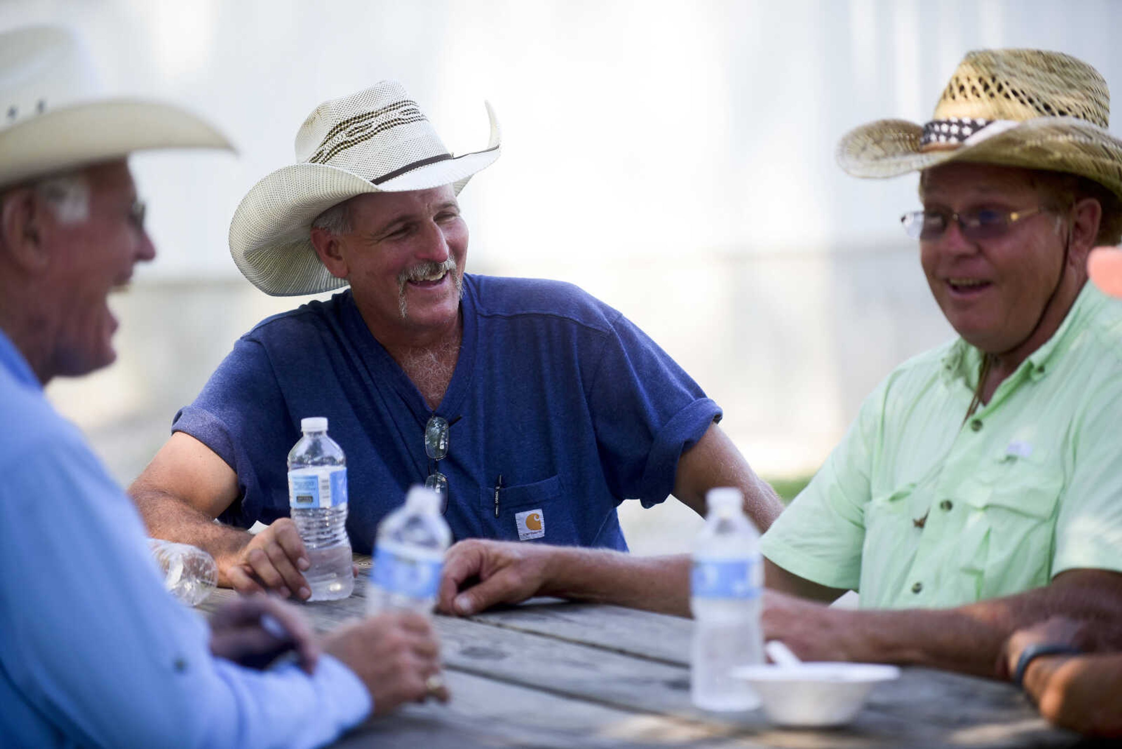 Tim Rhodes, left, Ivan Majka, center, and Jim Colvis, right, gather for the Trinity Church Picnic Sunday, July 16, 2017 at the Altenburg Fairgrounds.