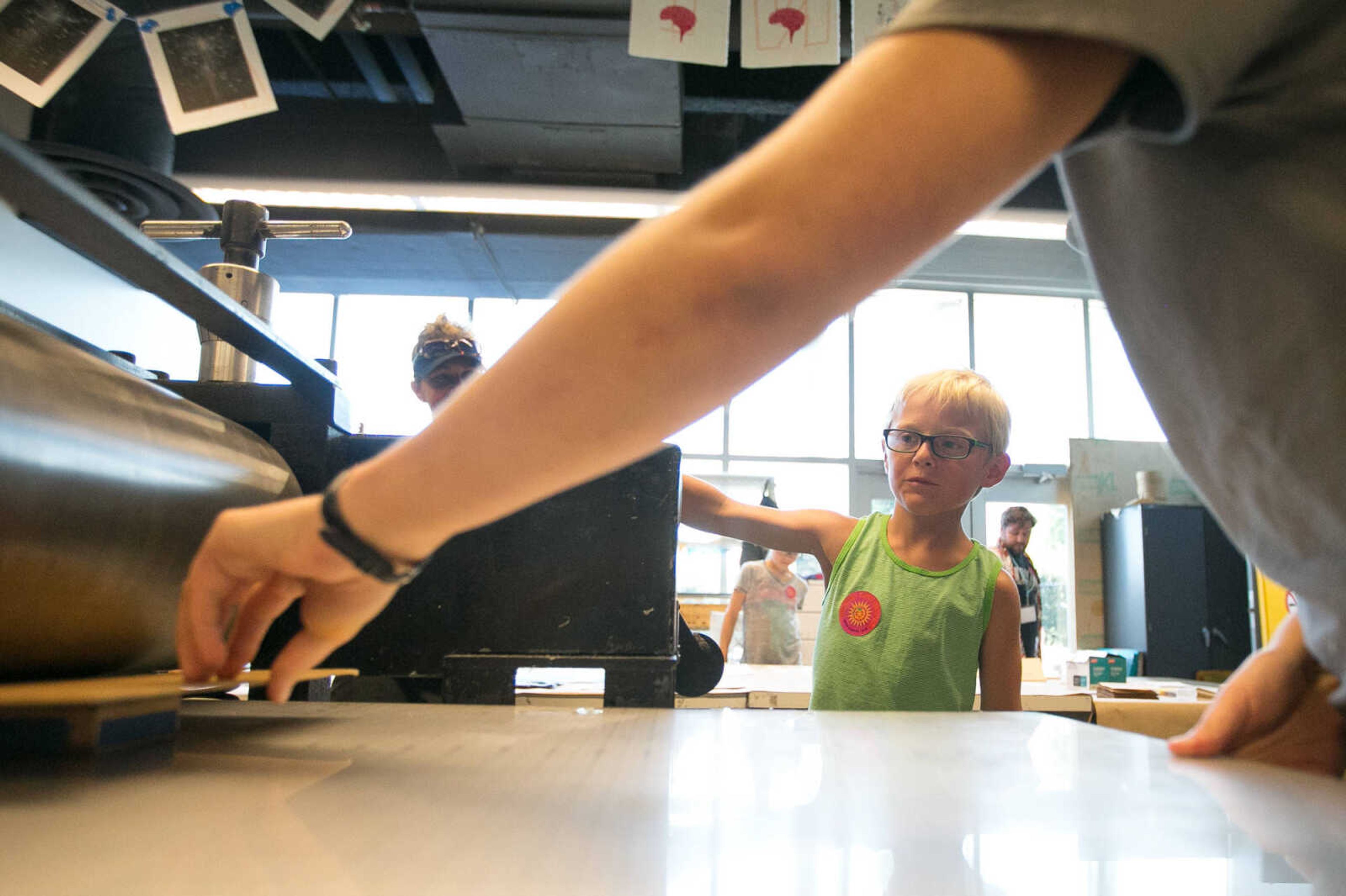 GLENN LANDBERG ~ glandberg@semissourian.com

Kids crank the handle on a printing press Saturday, June 18, 2016 at the River Campus Summer Arts Festival.