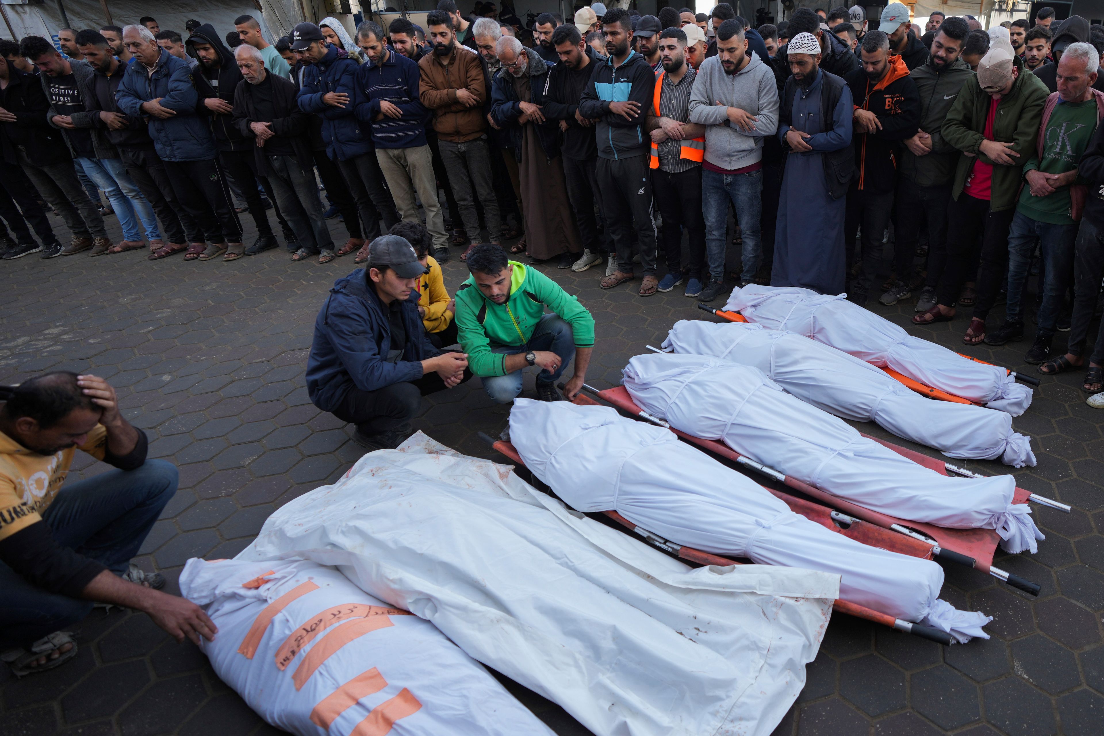 Palestinians mourn their relatives killed in the Israeli bombardment of Maghazi in the Gaza Strip, during their funeral at a hospital morgue in Deir al-Balah, Gaza, Thursday, Nov. 14, 2024. (AP Photo/Abdel Kareem Hana)