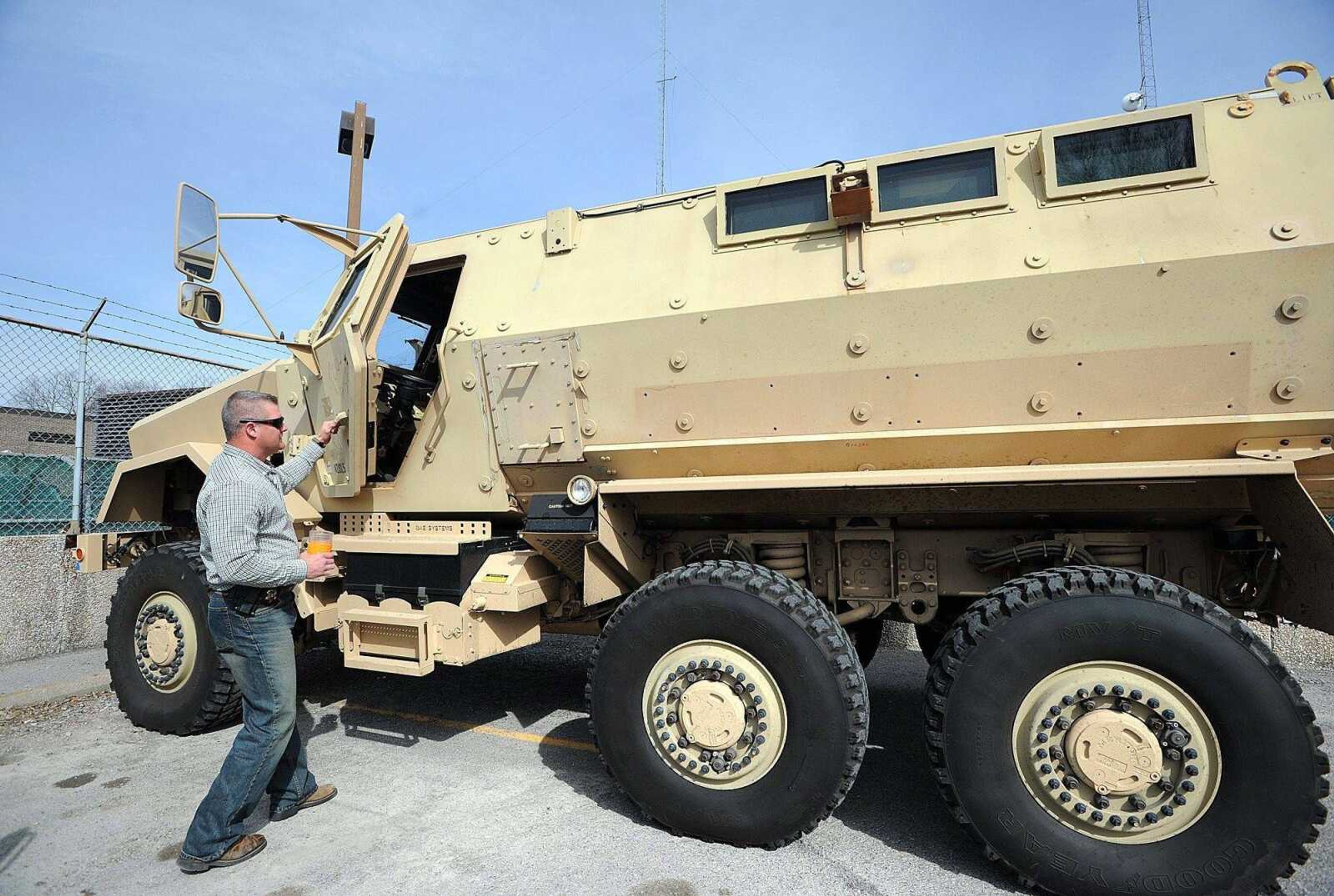 Lt. Chris Hull of the Cape Girardeau County Sheriff's Department opens the 700- pound driver's-side door to the department's mine-resistant ambush-protected vehicle March 21, 2014. Under federal legislation proposed Thursday, departments no longer would be able to receive MRAPs. (Laura Simon)