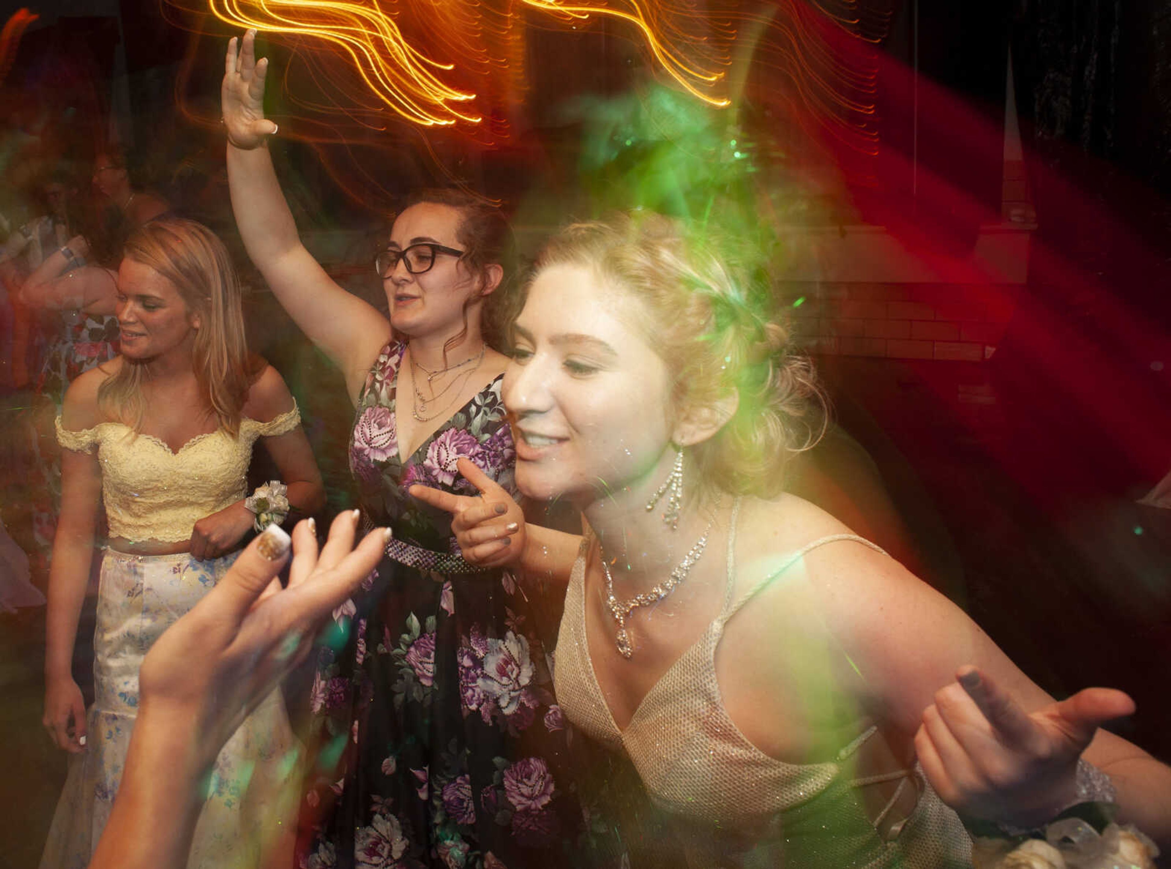 Leopold senior Mya Eldridge, center, dances next to Jackson senior Missy Brown, left, and Leopold junior Gwen Forrester during Leopold High School's "Masquerade at Midnight" prom Saturday, April 27, 2019, in Leopold.