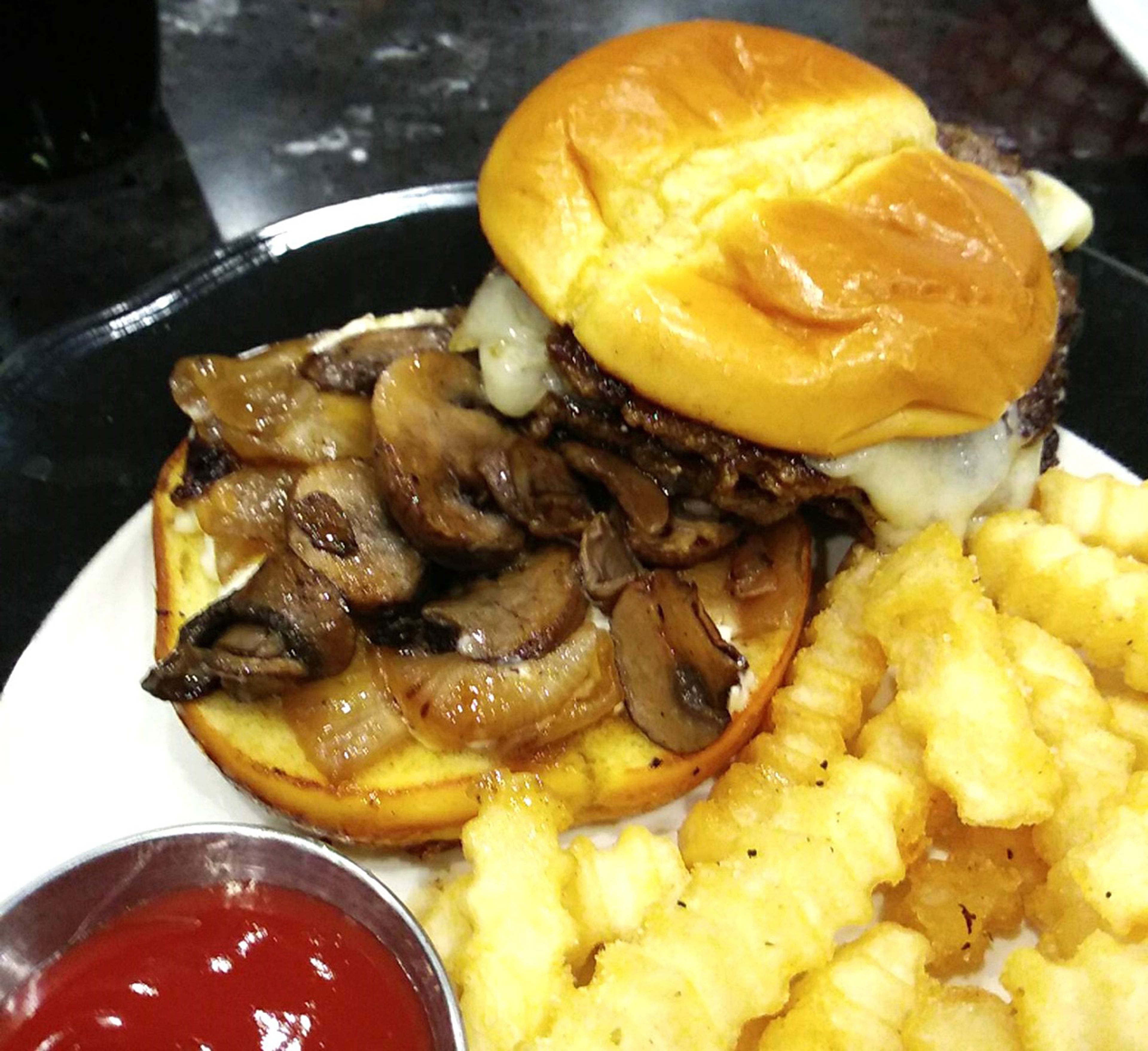 The Mushroom Swiss Smash Burger, taken apart so you can see the mass of mushrooms tucked under the burger. Delicious.