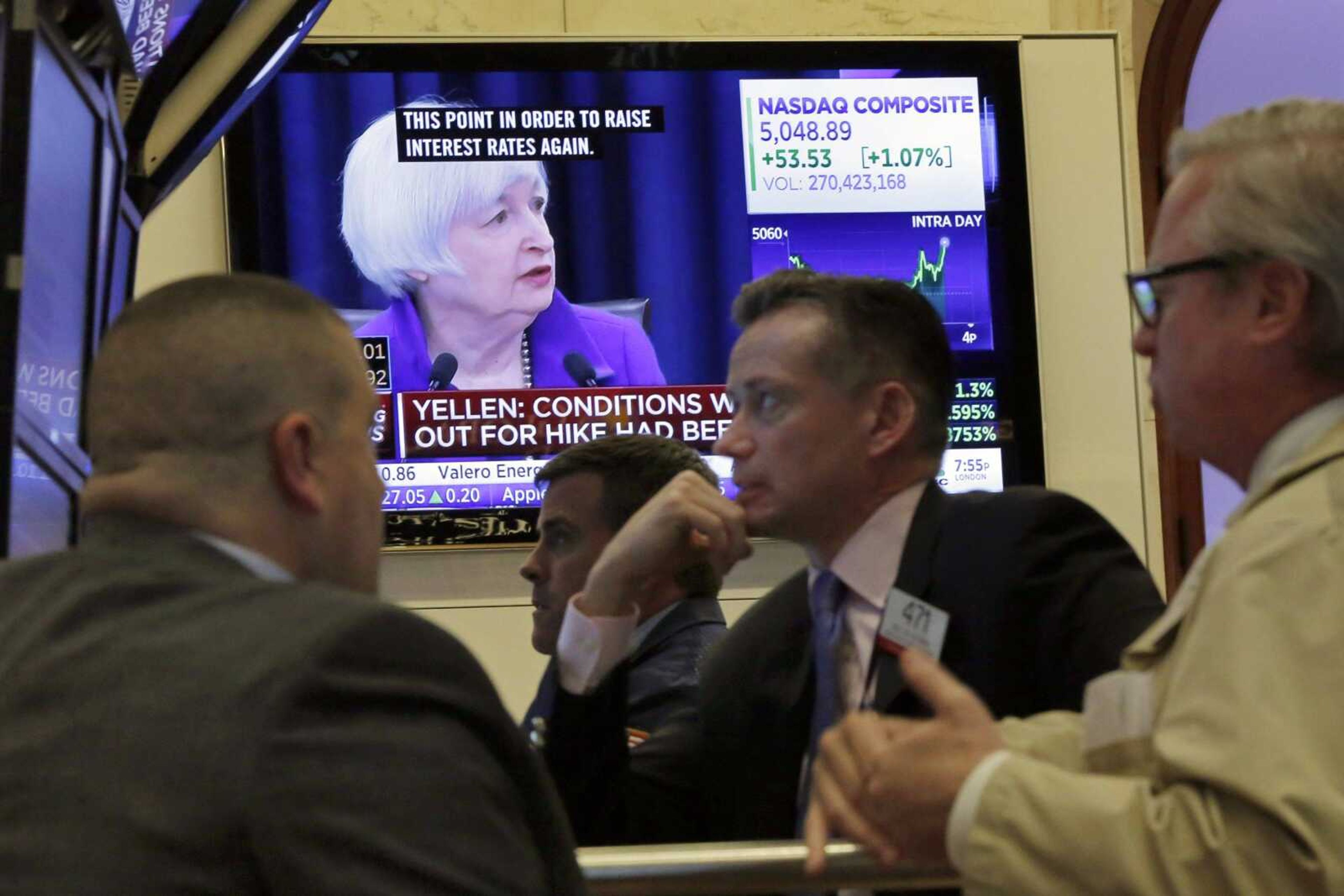 Federal Reserve Chair Janet Yellen's Washington news conference Dec. 16 is shown on a television screen on the floor of the New York Stock Exchange. (Richard Drew ~ Associated Press)