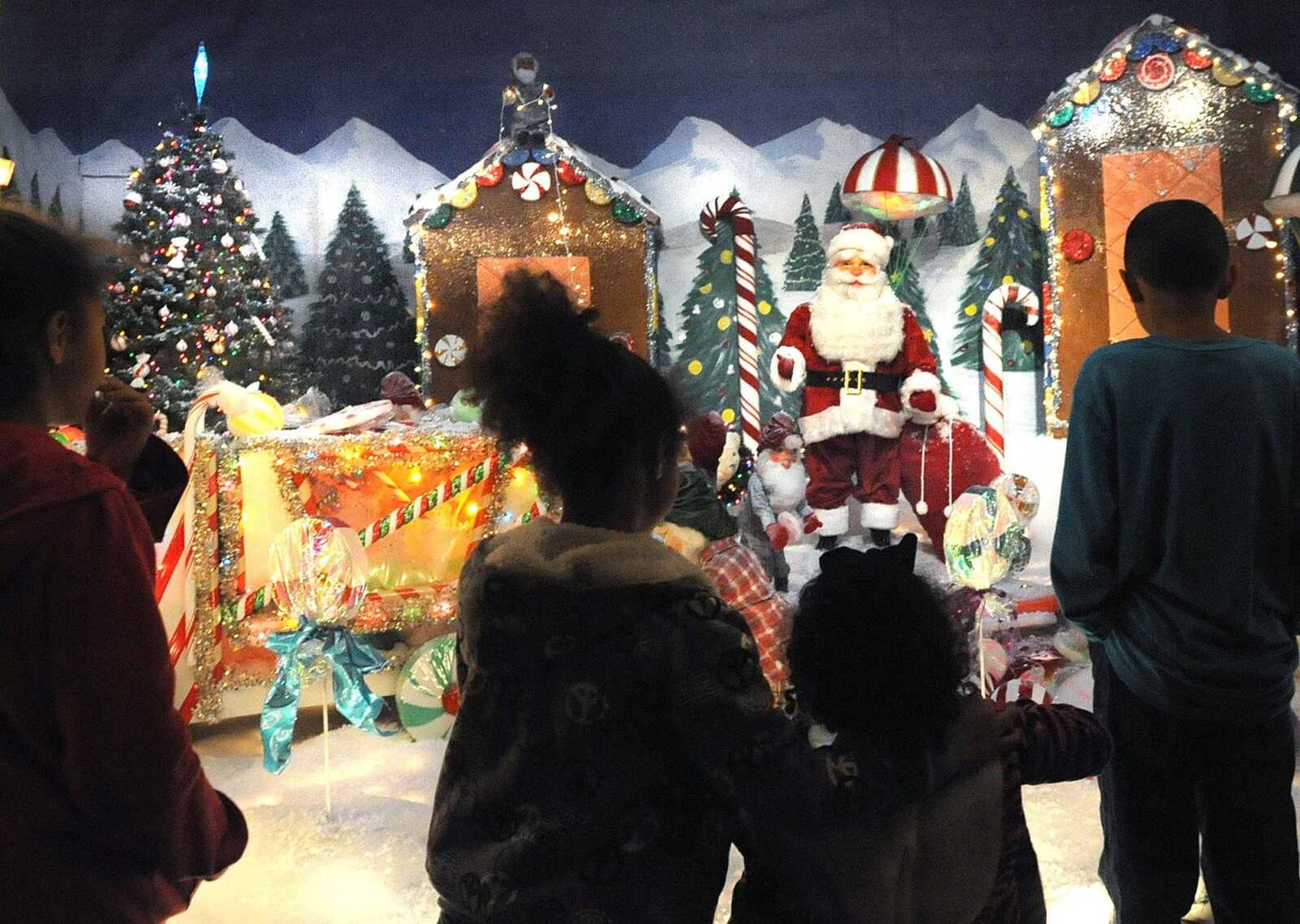 From left, Britain, Maicee, Dalyia and Brooklyn Sides look at the Christmas display in the window of Hutson's Fine Furniture Thursday evening in downtown Cape Girardeau. (Laura Simon)